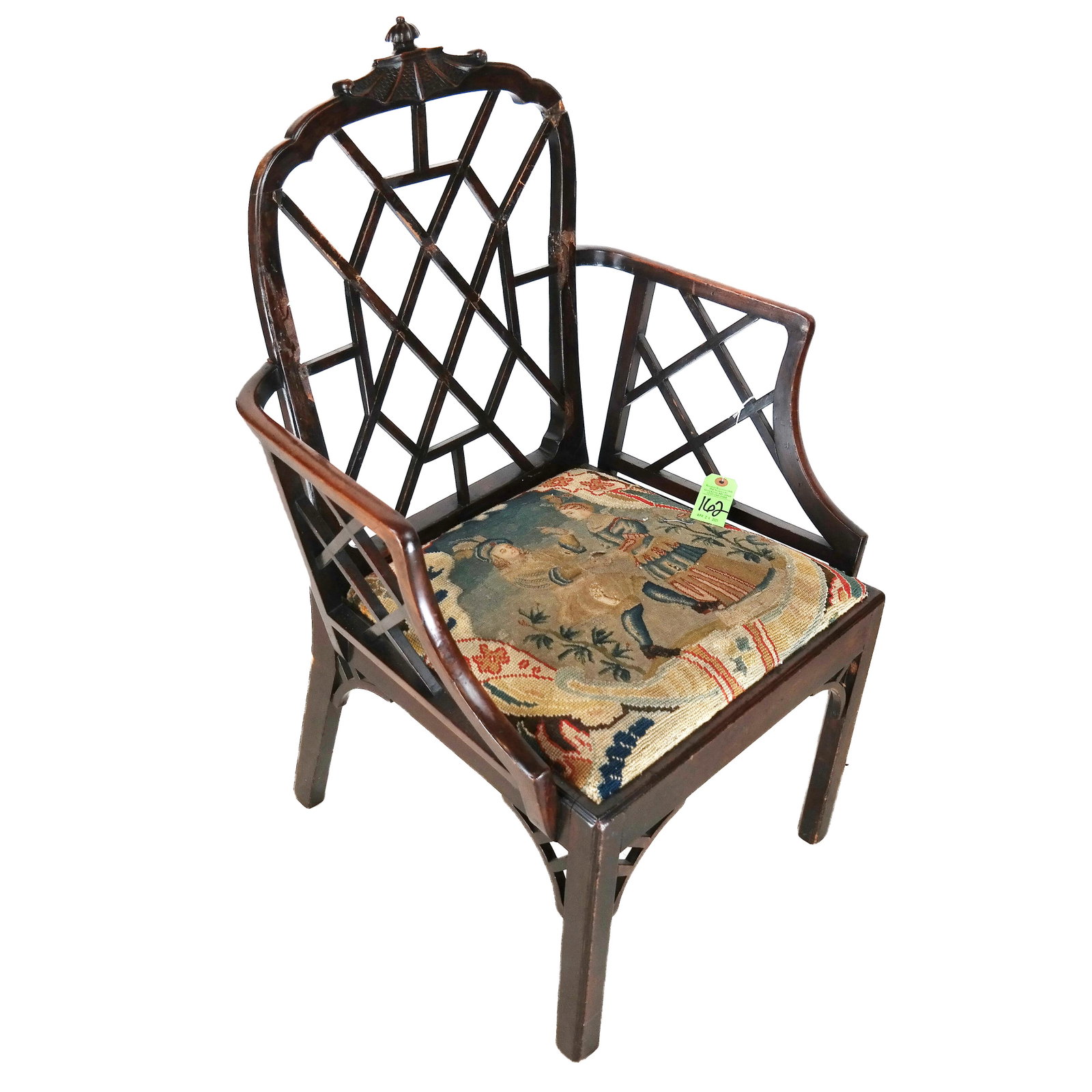 George III "Chinese" Trellis-Back Arm Chair: George III "Chinese" style trellis back mahogany arm chair, circa 1765,the cresting carved with a stylized pagoda top, the trellis inset canted arms centering a needlepoint seat, on straight chamfered