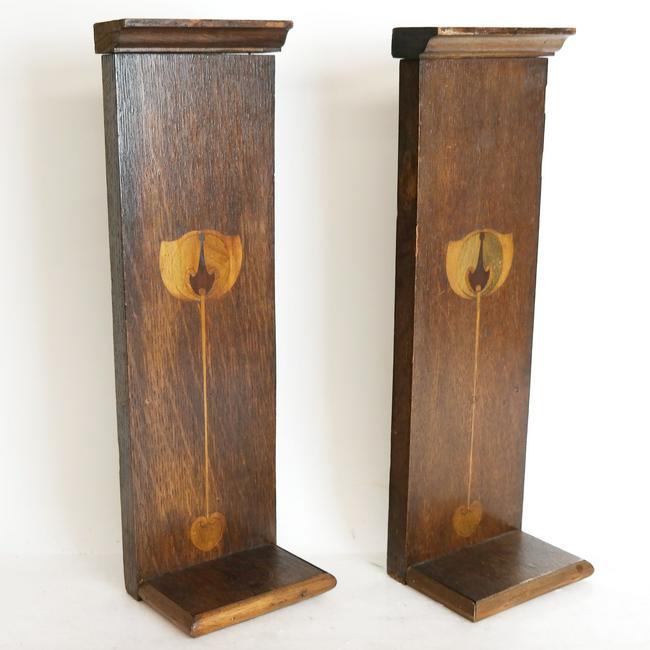 Pair of Art Nouveau Brackets: Pair of brackets with inlaid wood backs for holding figurines. [17" H x 4" W x 5" D].