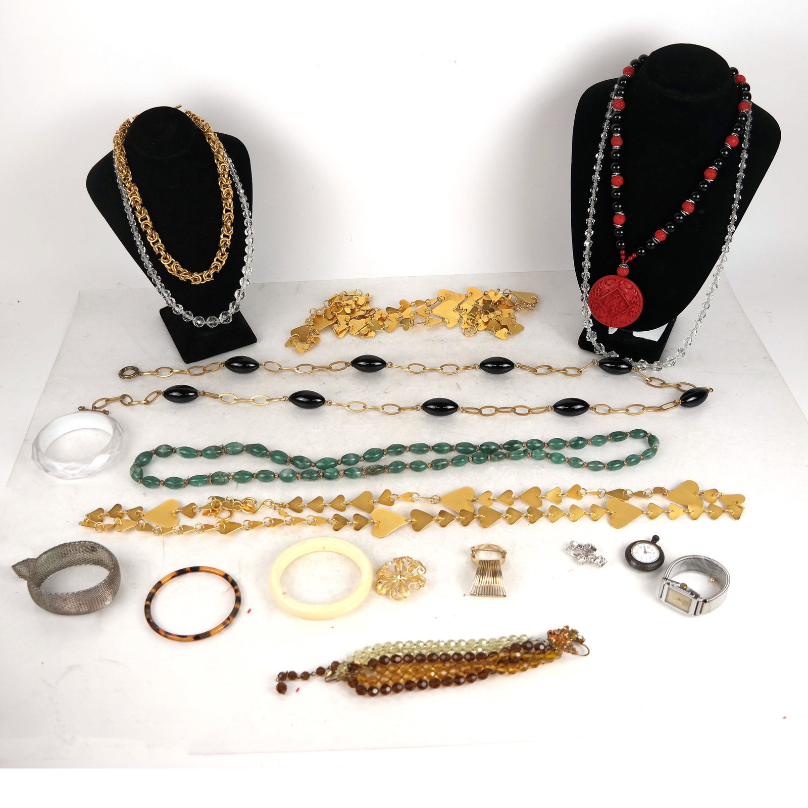 Bag of Costume Jewelry: Bag of costume jewelry, mostly necklaces, also a Bulova wristwatch, a Liana pocket watch inscribed "To Agnes Barris", bracelets, and a pin.
