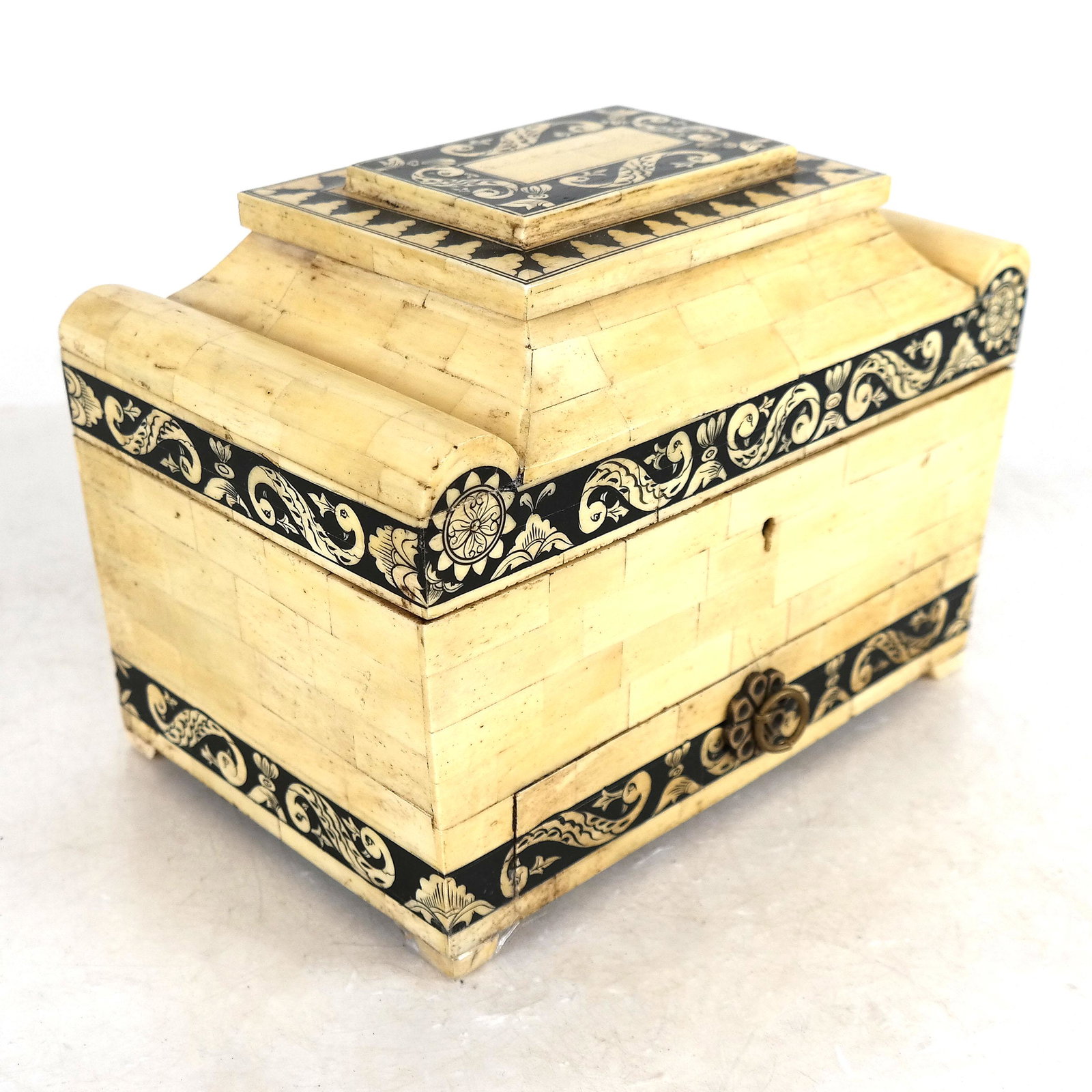 English-Style Bone Veneered Box: Casket-form with roll sides, hinge top and base drawer. Provenance: From the Upper East Side estate of a prominent NYC interior decorator. [7" H x 10" W x 6" D].
