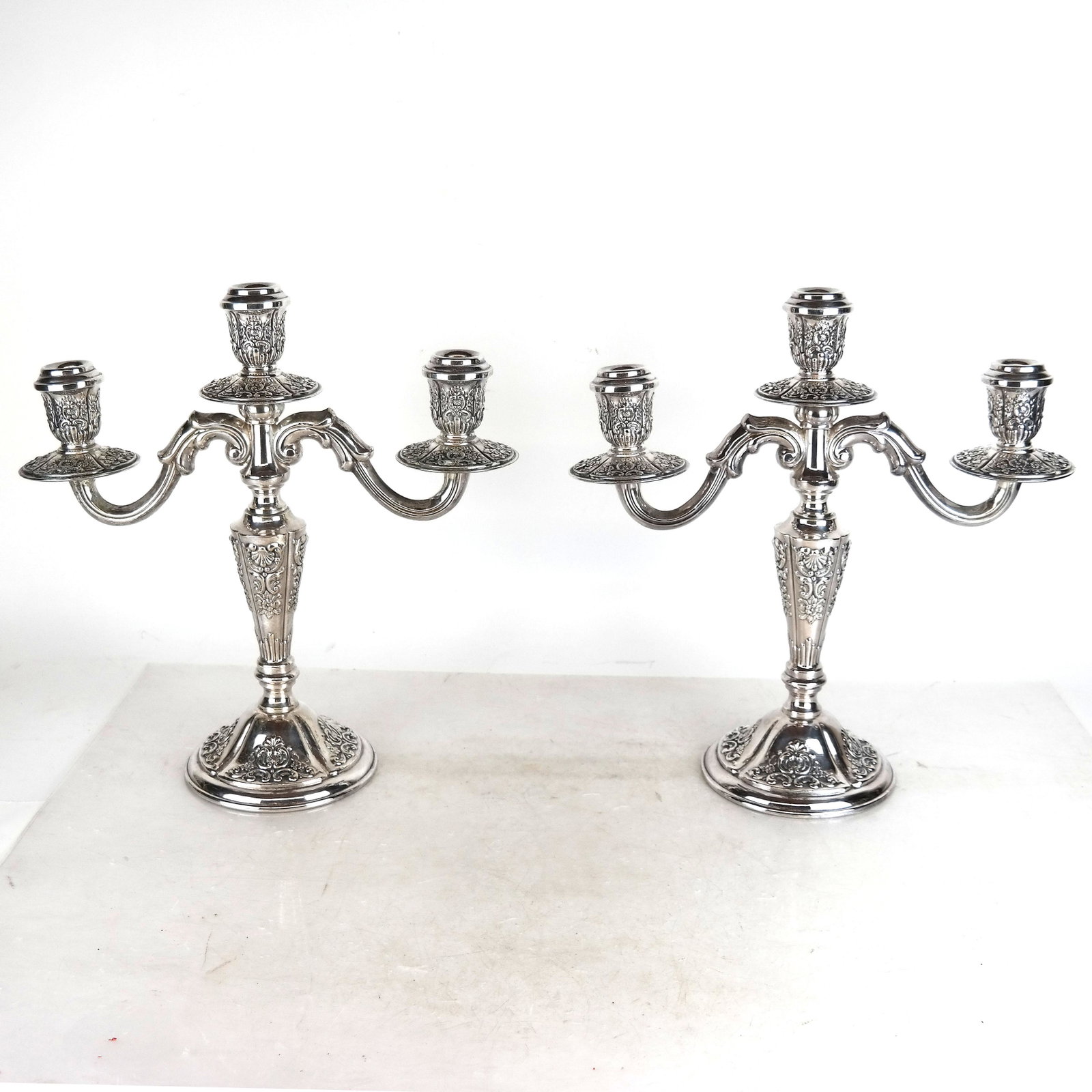 Pair of Spanish Alpaca Silver Candelabra: Pair of Alpaca silver candelabra, Made in Spain. [14" H x 13 1/2" W x 5" D]. In good condition.