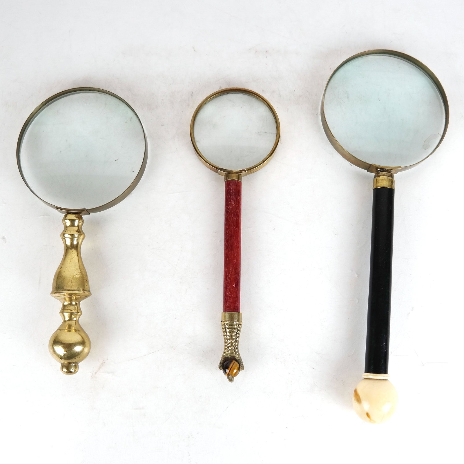 Lot of 3 Magnifying Glasses: Two figural brass handled magnifying glasses and one with a bone handle. [Longest: 13"].