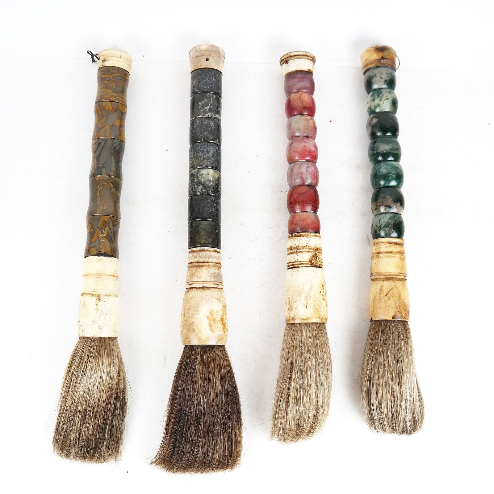 Lot of Four (4) Chinese Stone & Bone Brushes: L:ot of four Chinese agate and jasper and bone handled calligraphy brushes. {Longest: 17 1/2"]. In good condition.