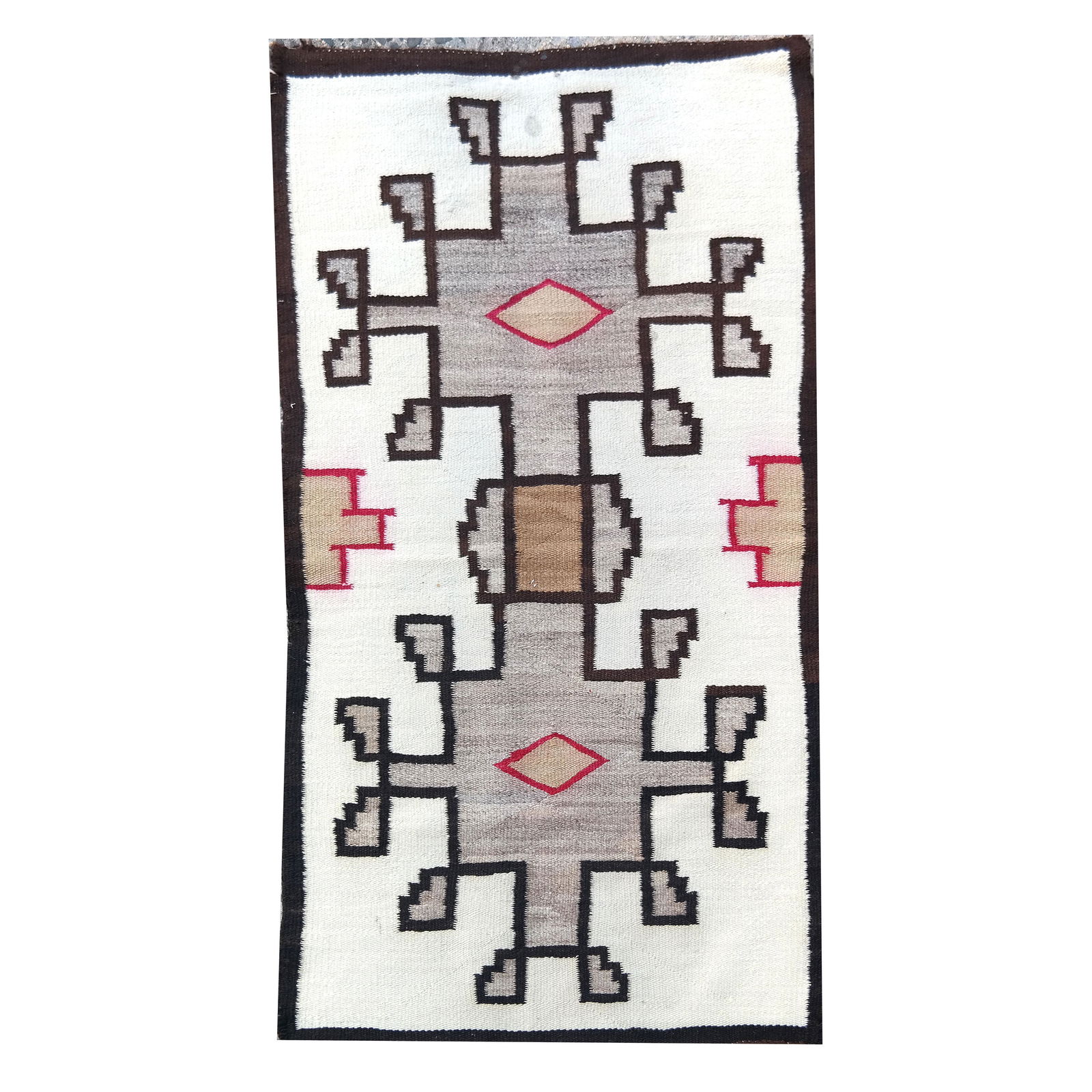 Navajo Geometric Runner Rug: Navajo geometric runner rug, with red, brown diamond motif. Provenance: The Estate of Roger Prigent - Malmaison. [54" x 28"]. Some stains.