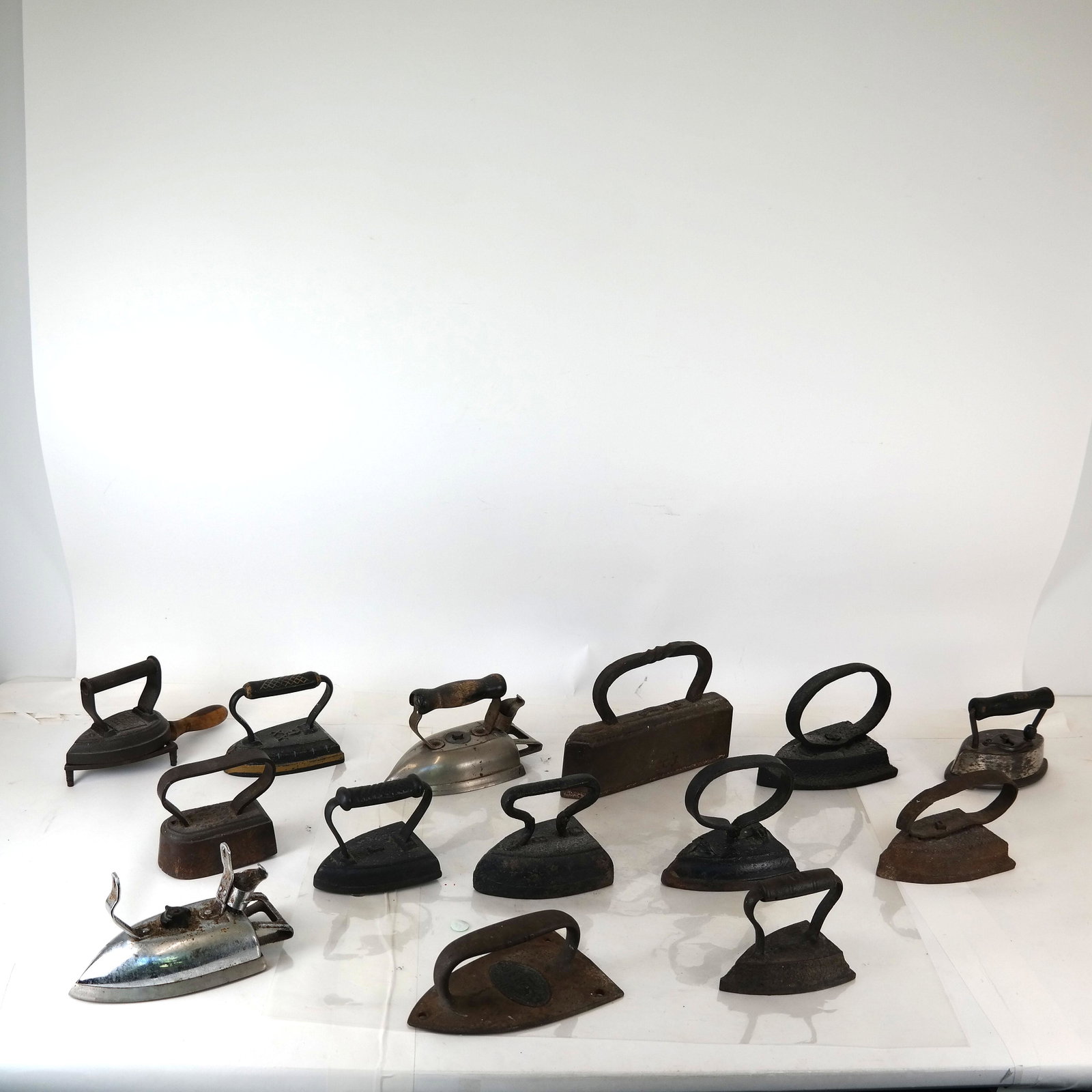 14 Vintage Irons: Cast iron, and others. Two electric "as-is".