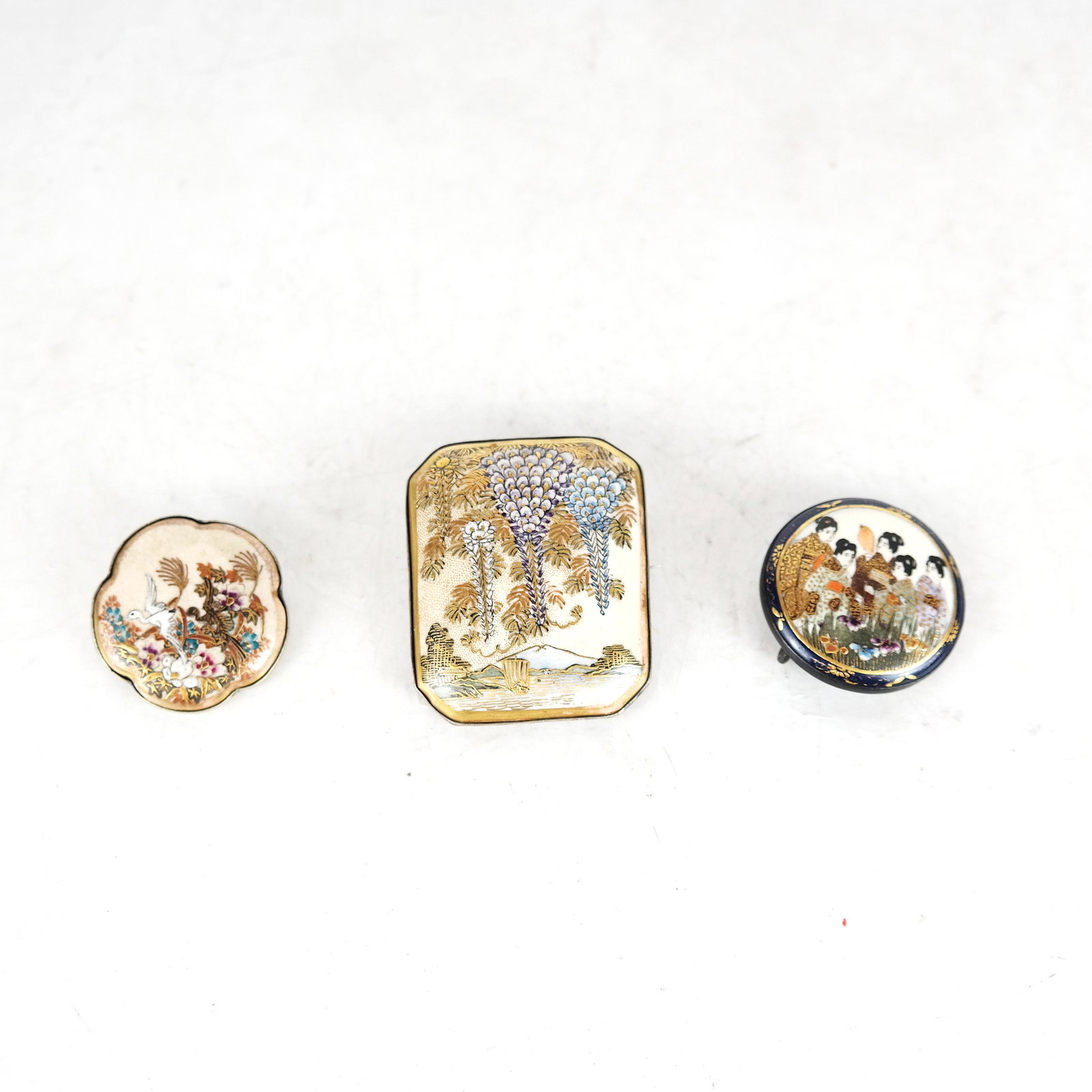 Satsuma Pins (2) and a Buckle: Two 20th century Japanese Satsuma maker pins and a buckle. [Largest: 2 1/4" x 1 3/4"]. In good condition.
