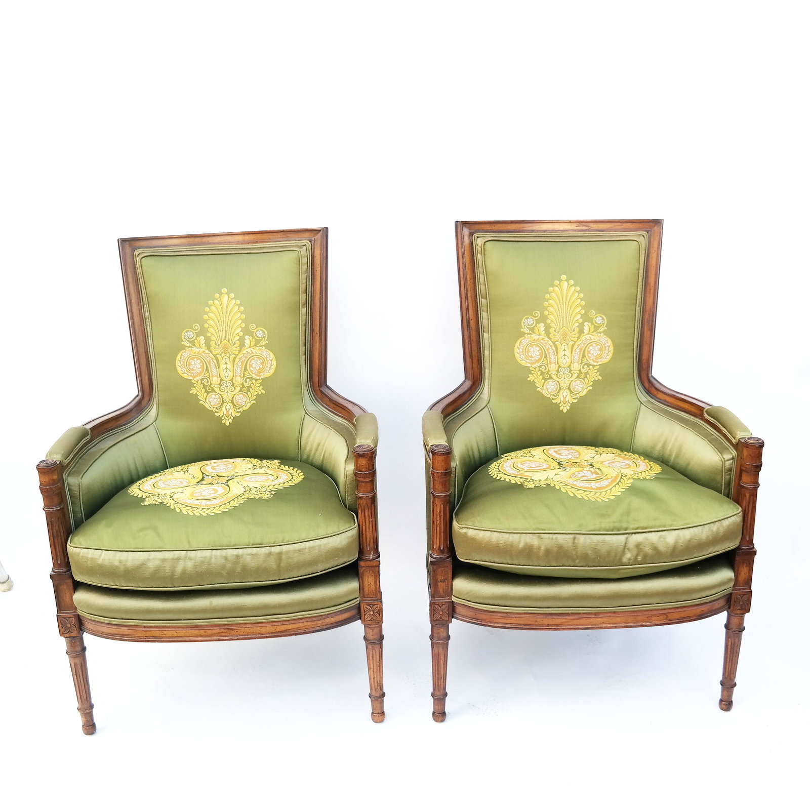 Pair of Louis XVI-Style Fruitwood Bergeres: Pair of 20th century Louis XVI-style fruitwood bergeres, having embroidered backs and cushions. [39" H x 26" W x 20" D]. In good condition.