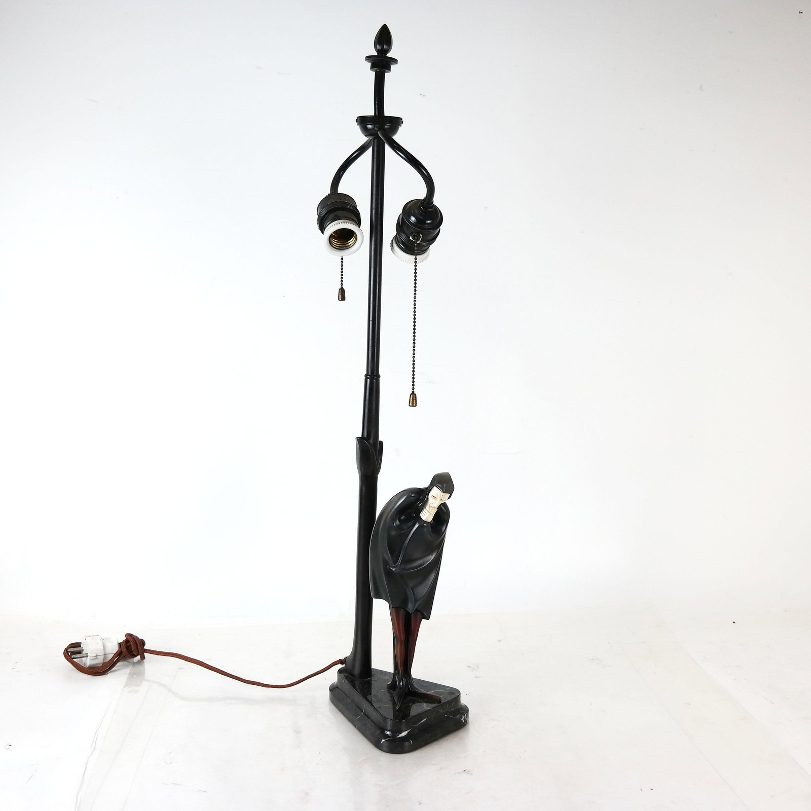 Art Deco Cold Painted Bronze Lamp "Mephistopheles": Art Deco cold painted bronze lamp circa 1930, of "Mephistopheles", with two lights, on black marble base, inscribed "Roland Paris". Face and hands are bone. [27 1/2" H to finial x 4 1/2" W x 6" D]. So