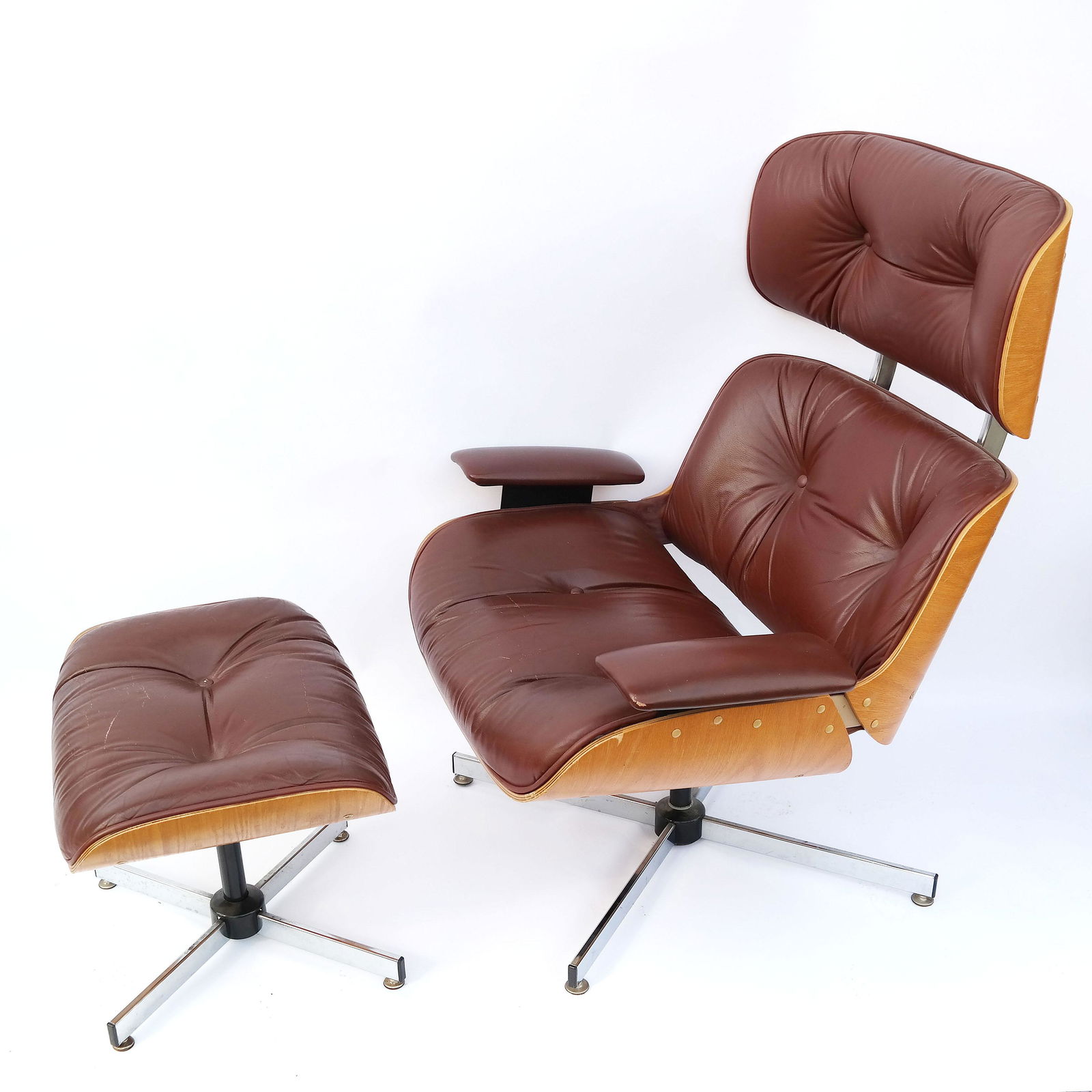Mid-Century Plycraft Chair & Ottoman: Mid-20th century Plycraft bentwood armchair & ottoman, having stainless steel bases with button-tufted brown vinyl upholstery. The chair is 30 x 30 x 38" high, the ottoman is 22 x 16 x 16" high. [Chai