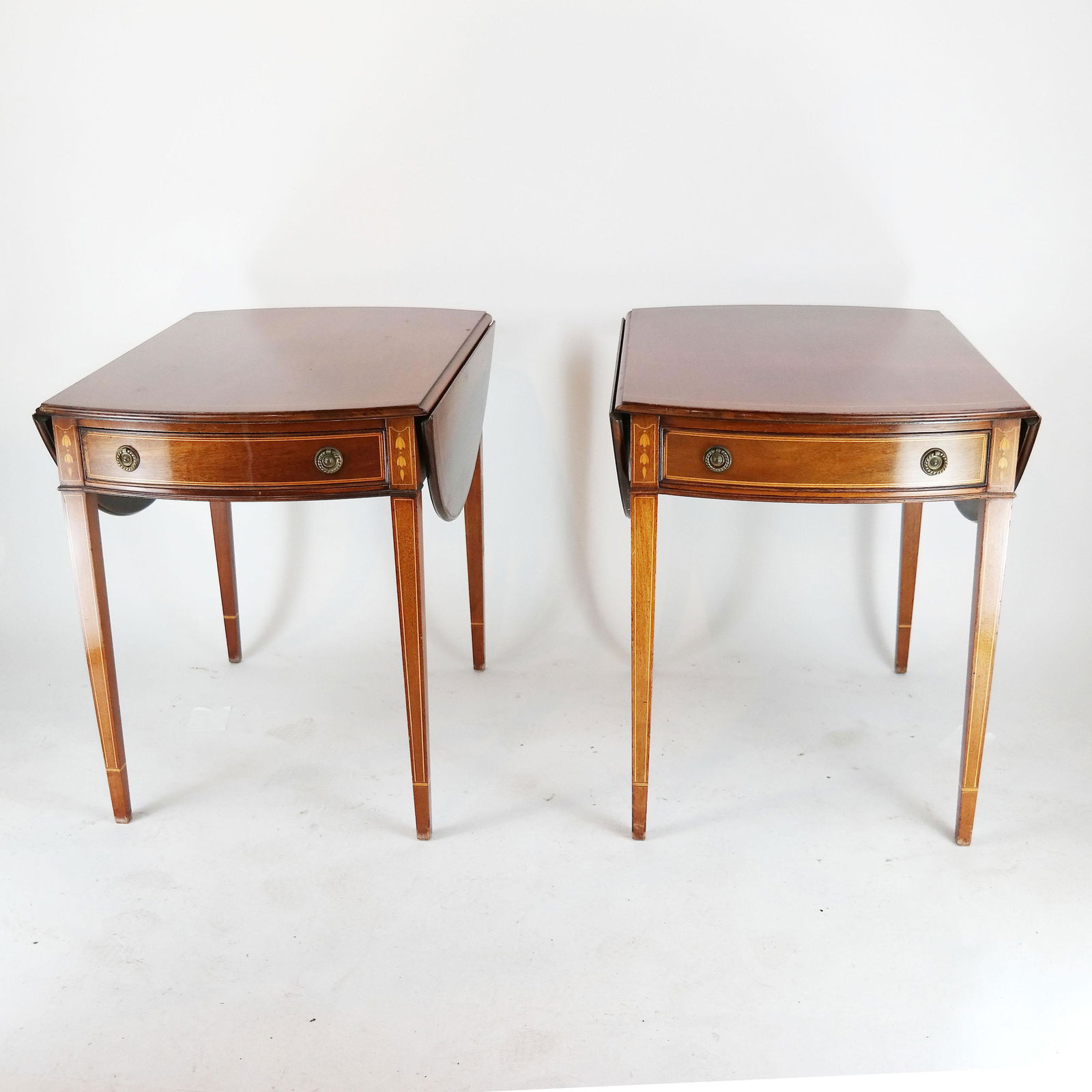 Pair 20th C. American Pembroke Tables: Pair of drop-leaf Pembroke tables, bell, flower, pencil design.