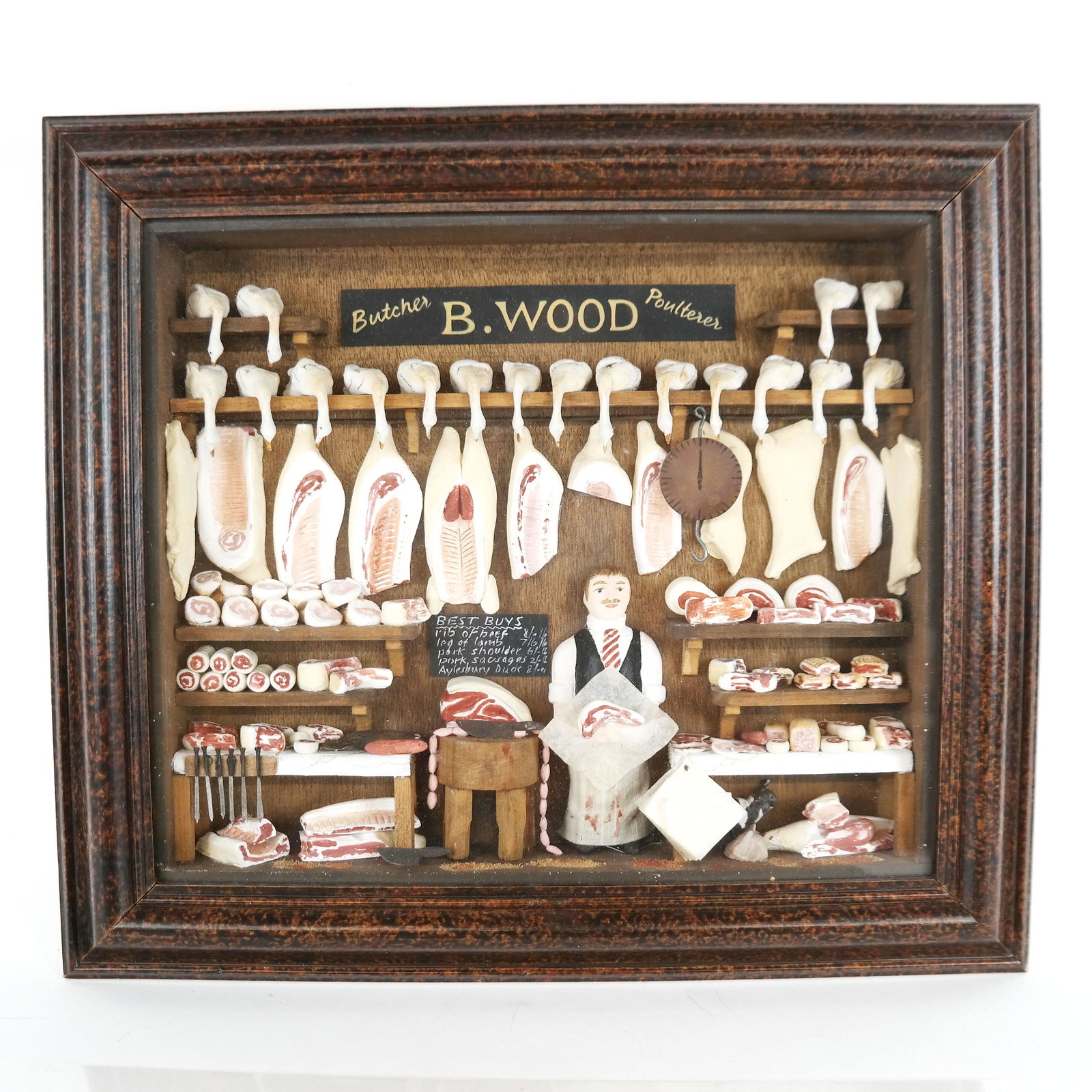 Diorama in Shadowbox: "B. Wood Butcher Shop" after the original in the Victoria and Albert Museum. [Art: 10" H x 12" W; Frame: 14" H x 16" W x 3" D]. In good condition.