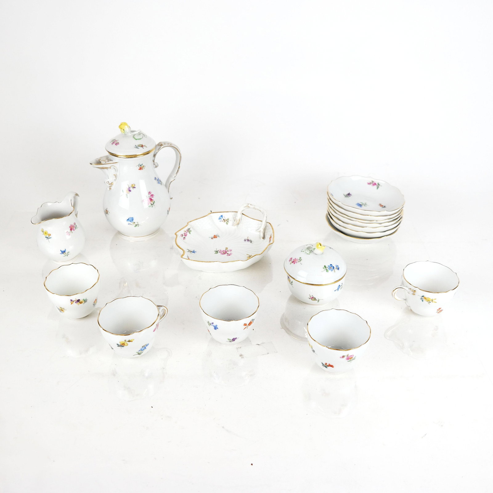 18-Pc. Meissen Demitasse Service: Meissen demitasse service including 7 cups, 7 saucers, a leaf dish, creamer, sugar and pot. [Pot: 7" H].
