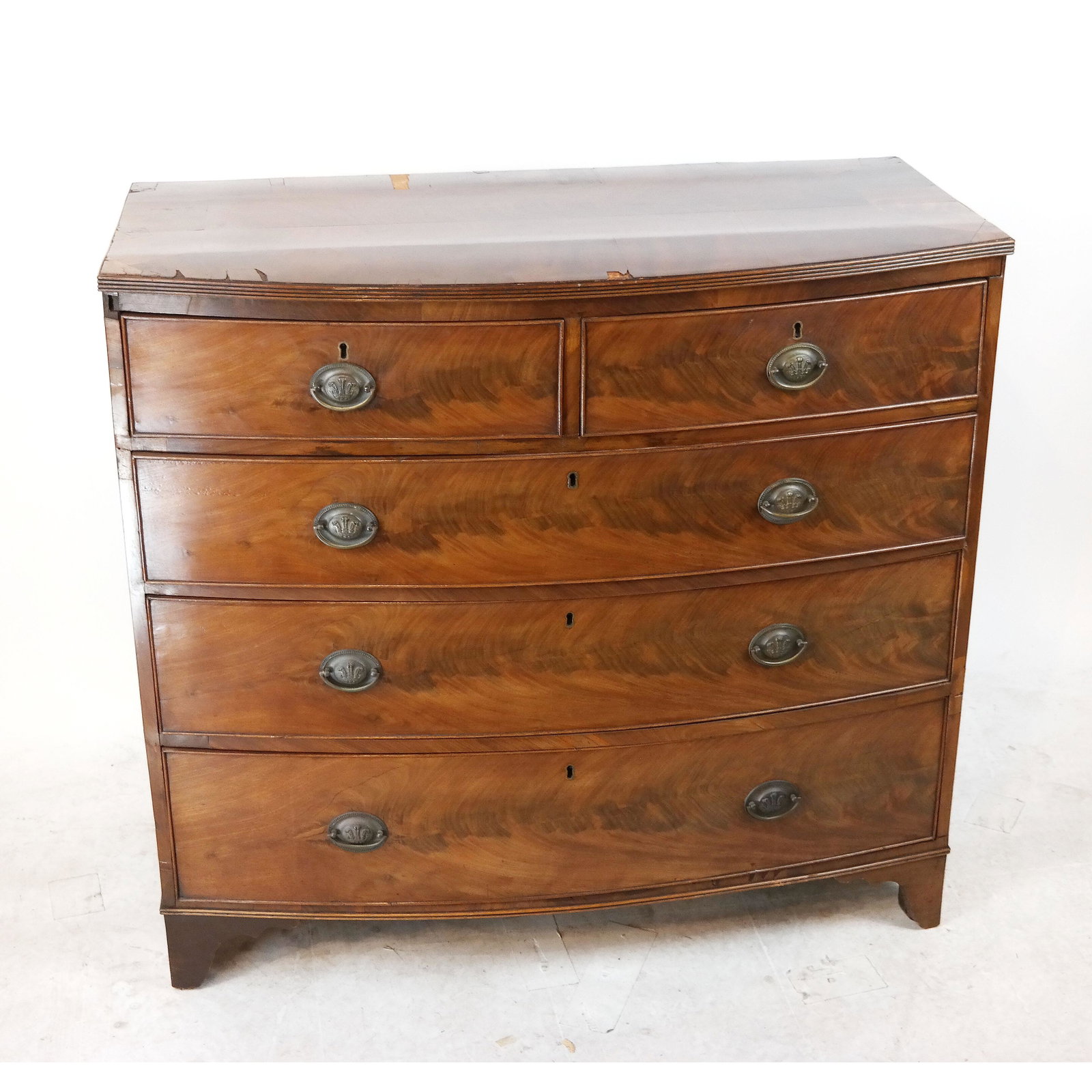 George III Mahogany Chest of Drawers: George III mahogany bow front chest of drawers. [39 1/2" H x 42" W x 21" D]. Veneer wear and losses; sticky drawers.