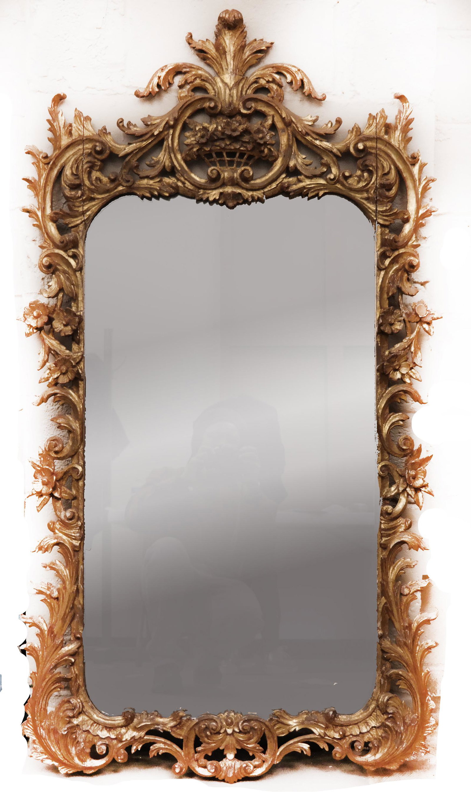 Antique Carved Gilt Wood Mirror: Large gilt wood mirror carved with scrolls and flowers. [59" H x 32' W]. Cracks; losses.