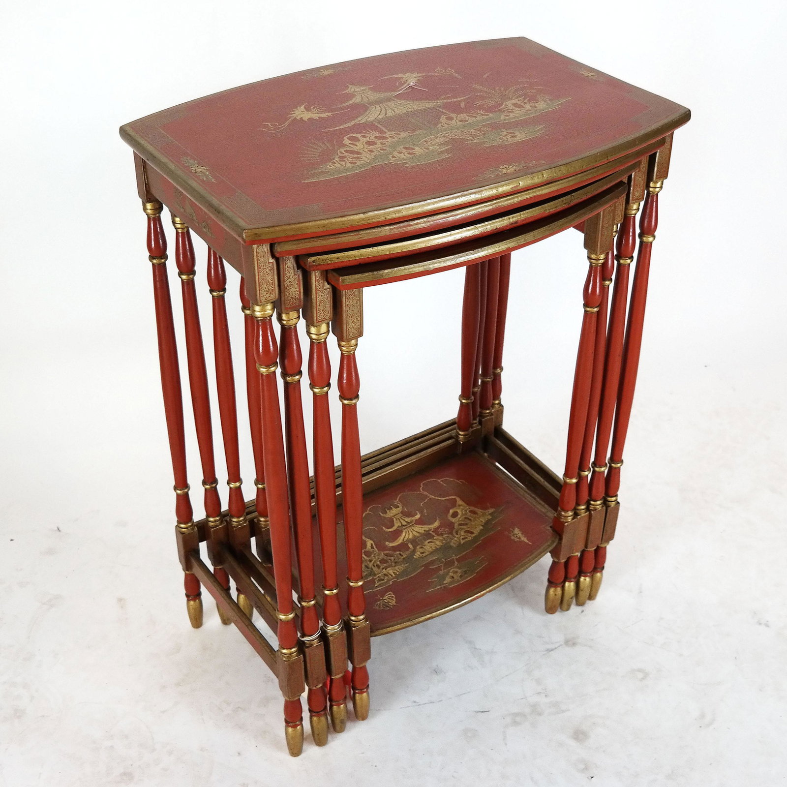 Nest of 20th C. Chinoiserie Quartetto Tables: Nest of Chinoiserie red and gilt japanned quartetto tables, each decorated with stylized landscapes and buildings, re-decorated. Provenance: Christie's, London "Interiors" sale, August 17, 2016, lot 2