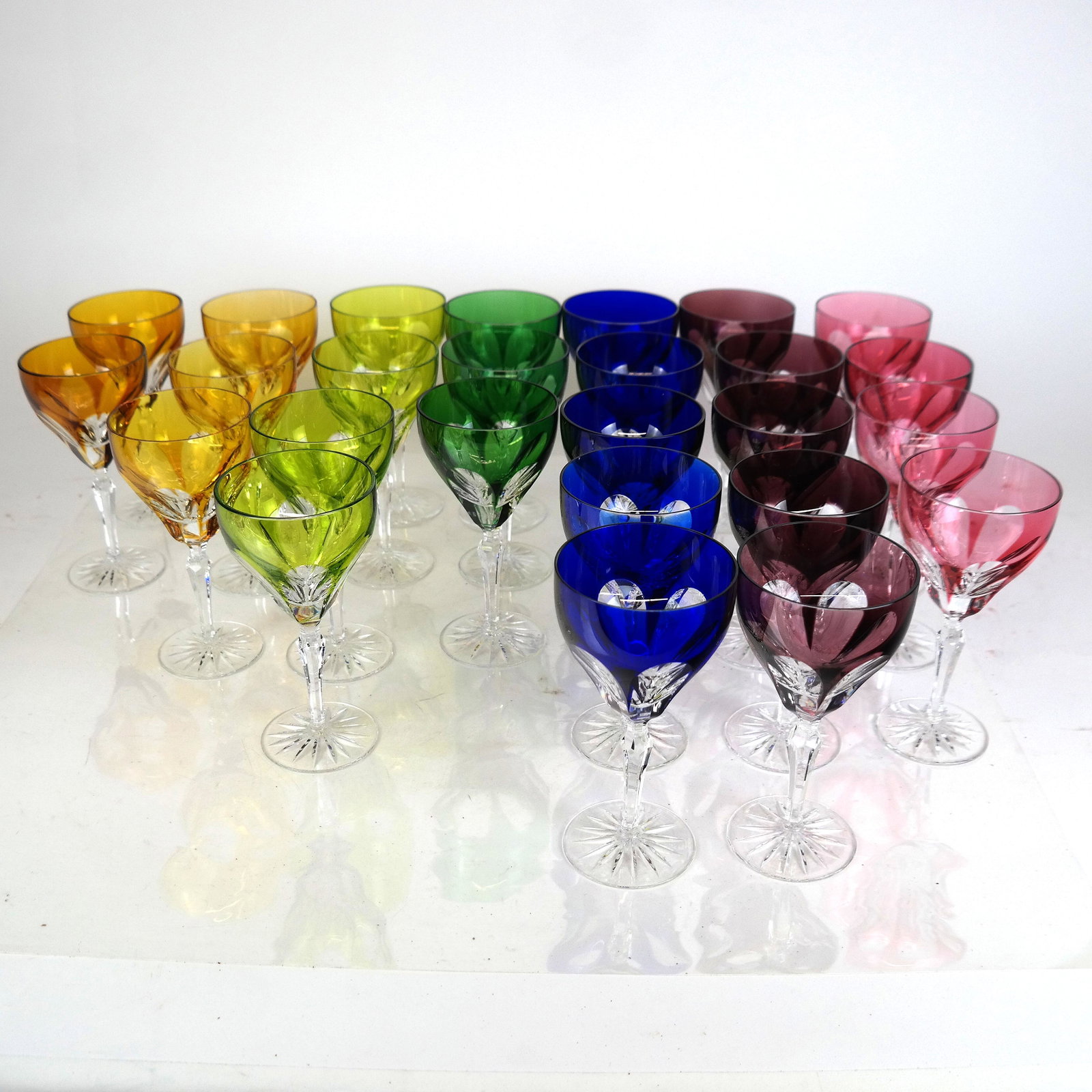 Set of 26 Bohemian Glass 6" Goblets: Set of Bohemian crystal wine glasses / goblets, in an assortment of jewel colors, having cut crystal bases and thumb print cups. [6" H]. In good condition; no chips.