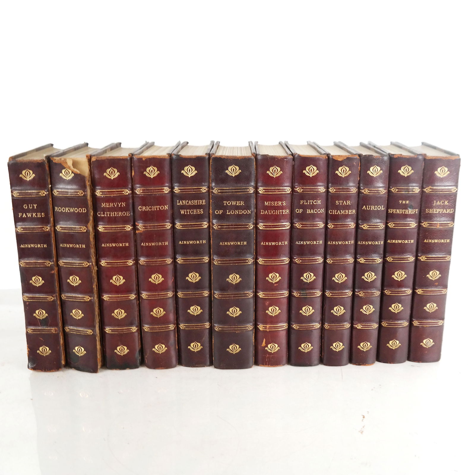 BOOKS: 12 Wm. Harrison Ainsworth Volumes: SEt of 12 matching volumes containing works by William Harrison Ainsworth, pub. George Routledge & Sons, London, N.D. 8vo, all leather bound with hubbed and gilt stamped spines bearing marbleized boar