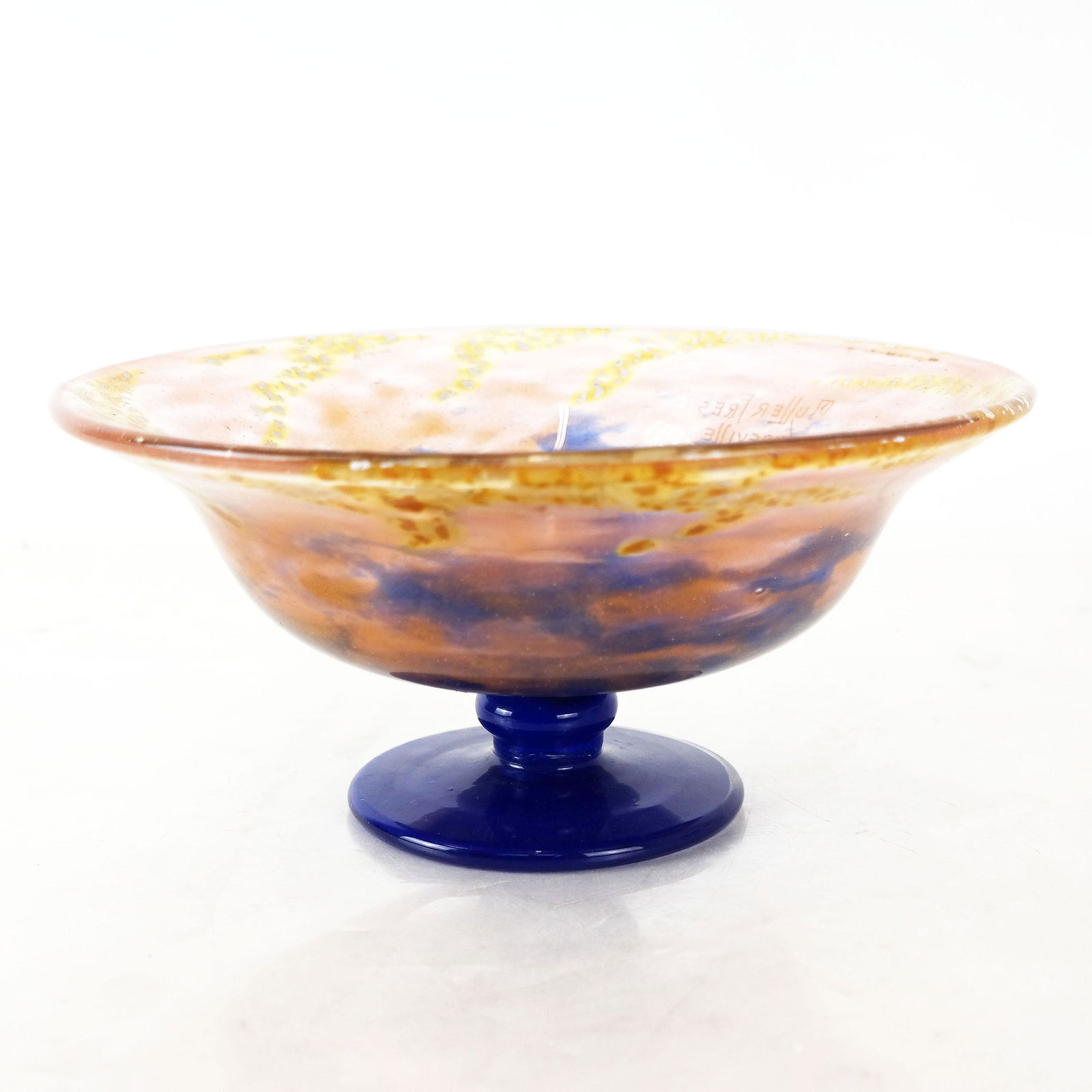 Muller Freres Glass Footed Bowl: Early 20th century Muller Freres glass footed bowl with internal metallic accents; signed to side "Muller Fres Luneville." [4 3/4" H x 9 1/2" Diam.]. Internal bubbles; residue to interior; scuffs to b