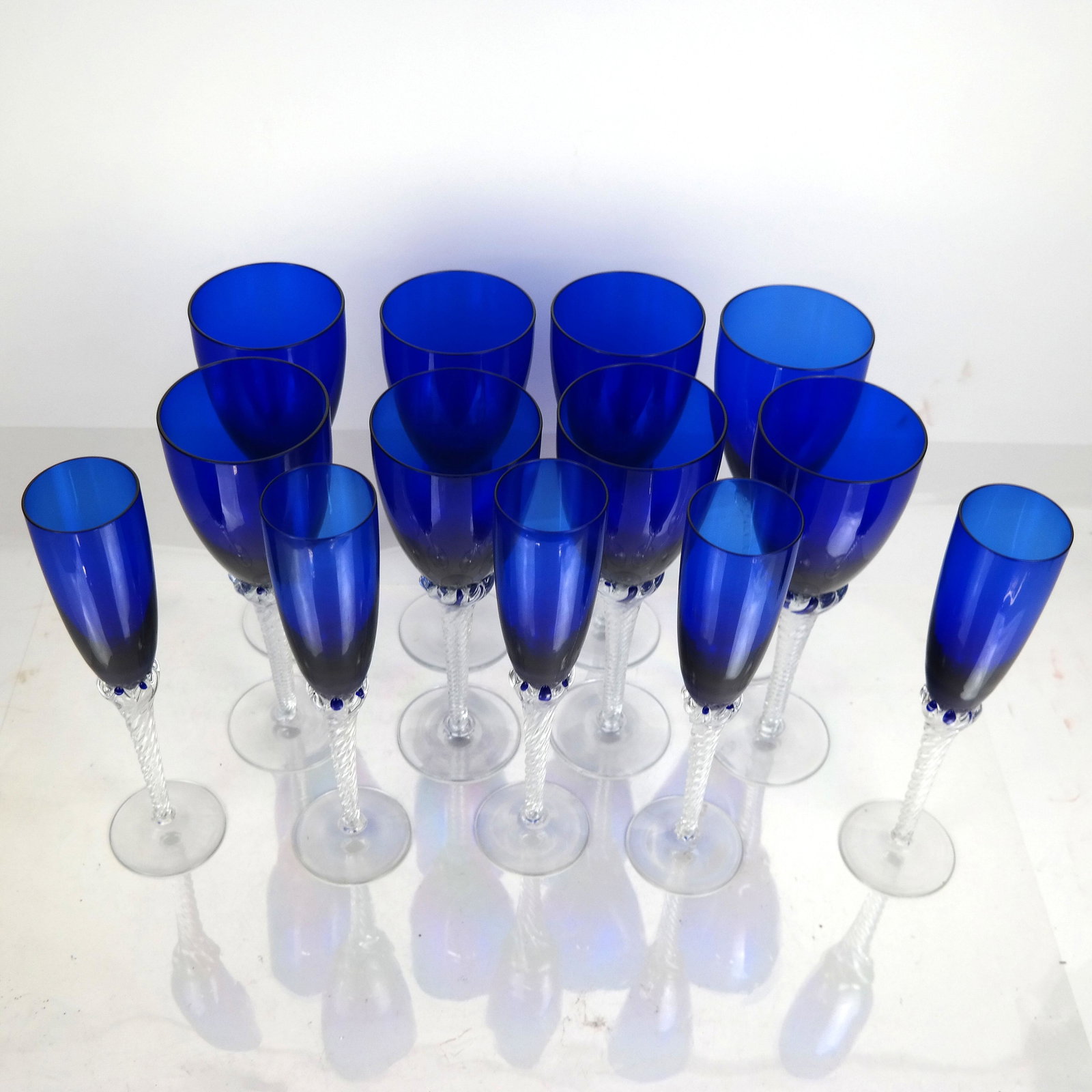 Lot of 13 Cobalt & Clear Crystal Stems: Lot of 13 cobalt blue and clear crystal wine glasses / champagne flutes. [9" - 9 1/2" H]. In good condition; no chips or cracks.