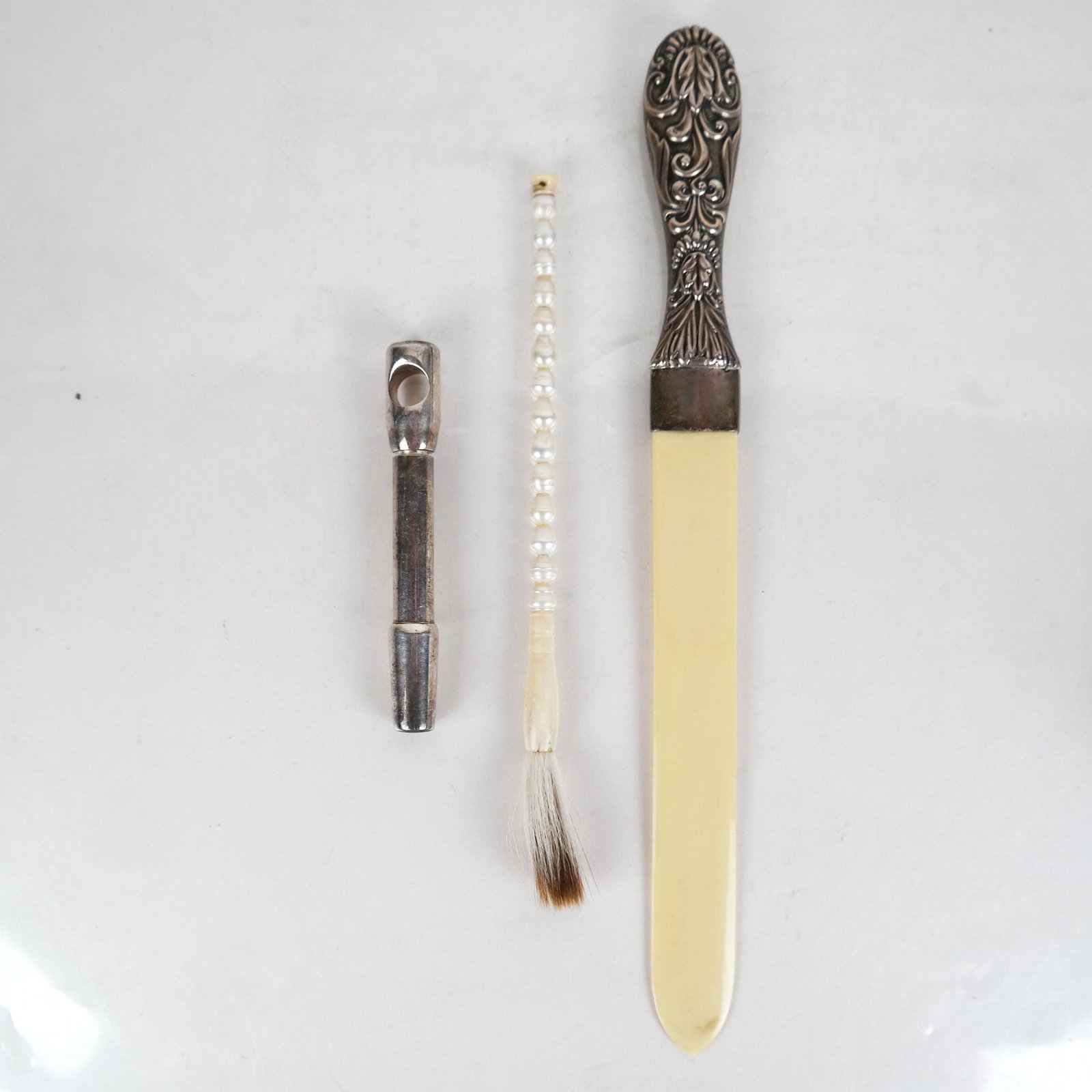 Sterling, Bone Paper Knife; Brush & Corkscrew: A repousse sterling silver handled paper knife, marked "FEG" with British hallmarks, circa 1940s [12 3/4" L], together with a Reed & Barton silver plate corkscrew [4 5/8" L] and a pear and bone handle