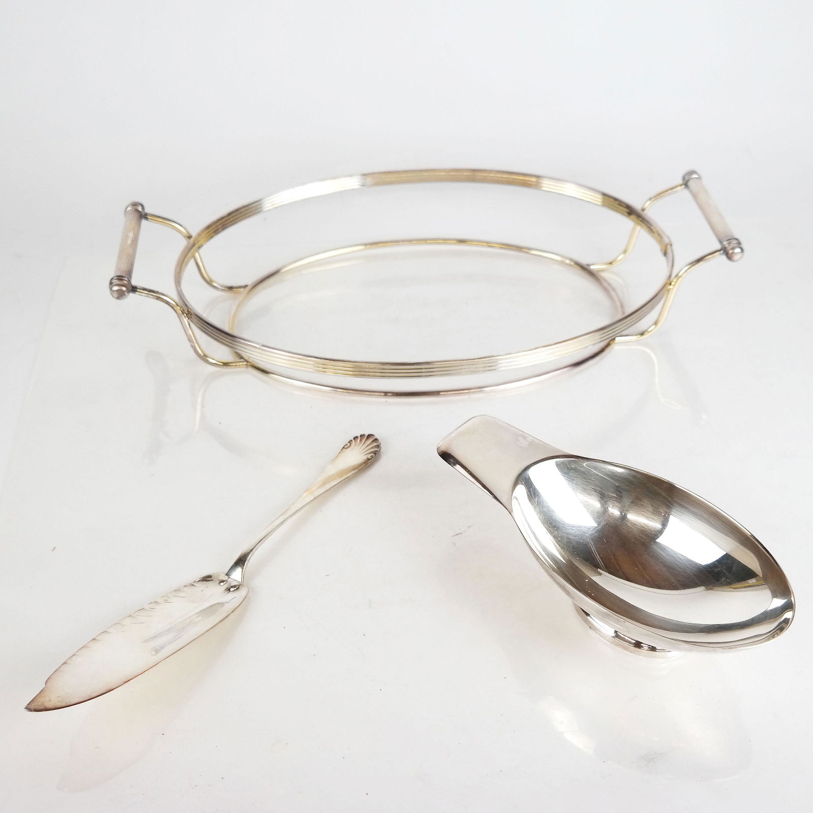 Three Christofle Articles: Three Christofle articles, including a serving slice, an oblong gravy boat and a centerpiece/server without liner.