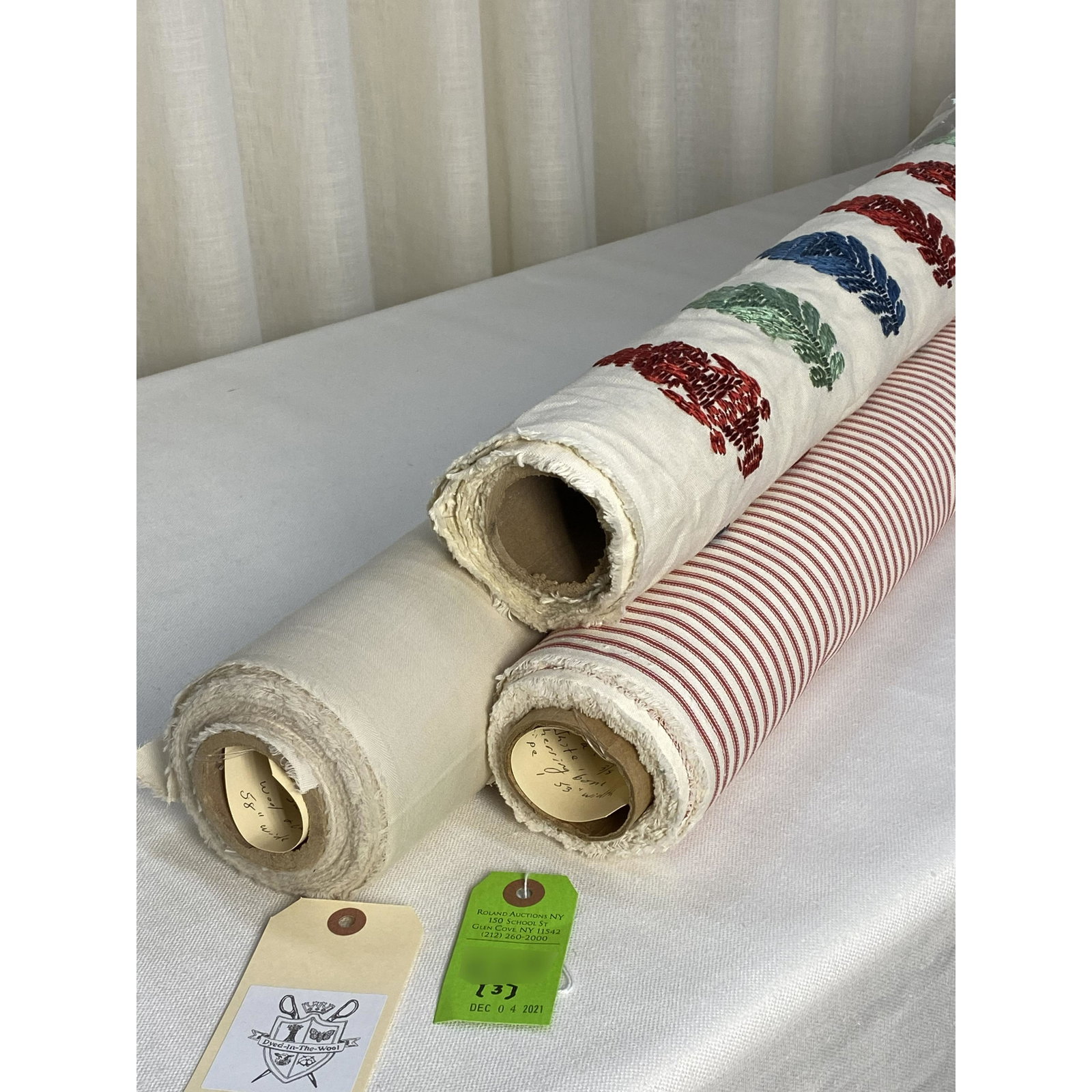 Holland & Sherry, Embroidery & Stripe Fabrics: 1) 3 yards of a heavy tram silk embroidery on ivory linen, 57" wide. The red, blue and light jade stylized flowers has a design repeat of 9 1/2" vertical by 14" horizontal. Minor rust stains at the on