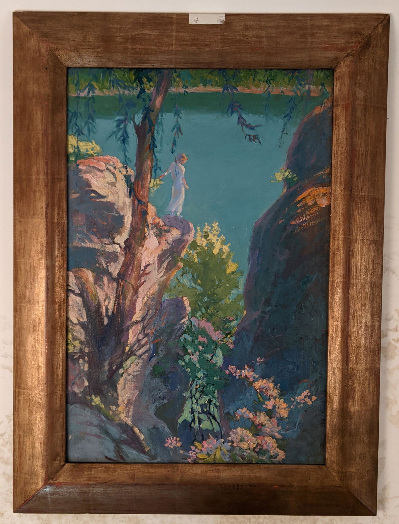 Woman by a Mountain - Oil Painting: Gilt framed oil on canvas painting of a woman standing on a mountainside cliff over water. Unsigned. [Art: 19 3/4" H x 29 1/2" W; Frame: 27" H x 37" W]. In good condition.