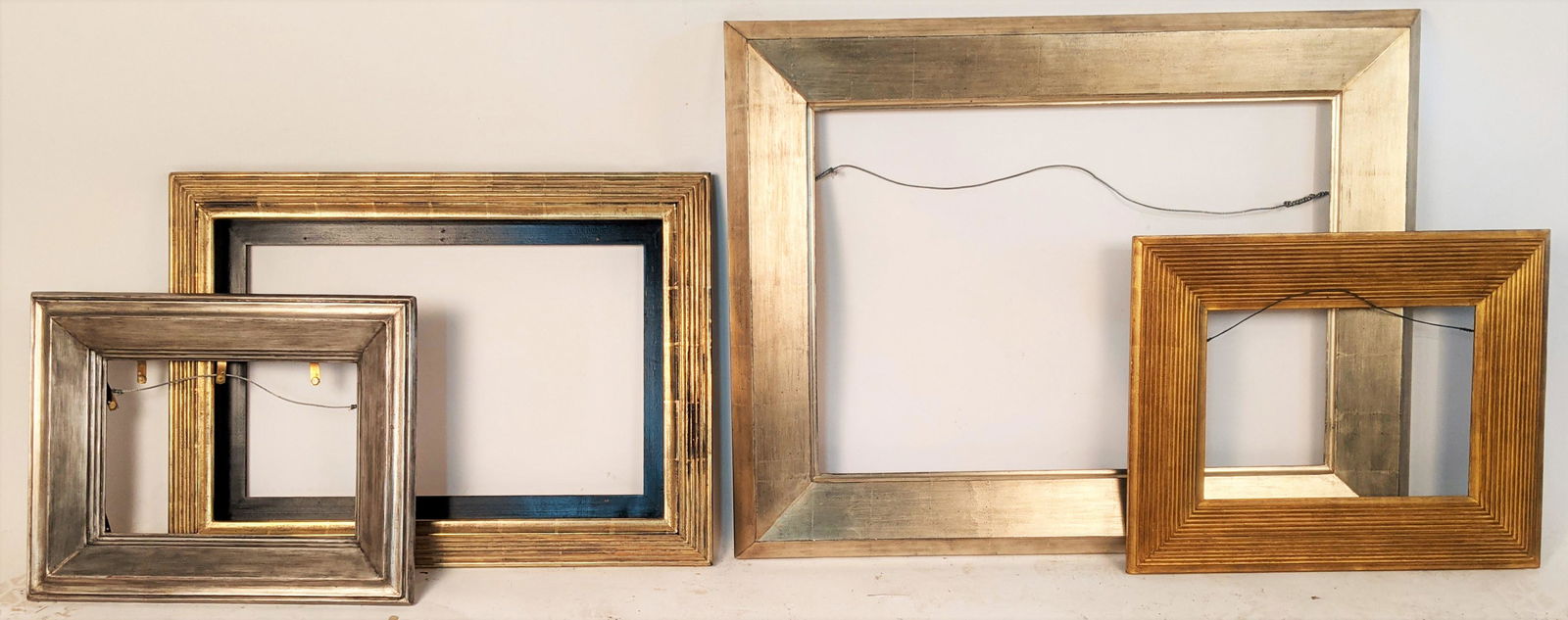 Lot of 4 Silver & Gold Gilt Frames: Lot of 4 silver and gold gilt frames, one by Eli Wilner. [Outside: 29 1/8" H x 37" W; Rabbet: 20 1/2" H x 28 3/8" W; Outside: 22" H x 30" W; Rabbet: 16 1/2" H x 24 1/2" W; Outside: 18 1/4" H x 22 1/8"