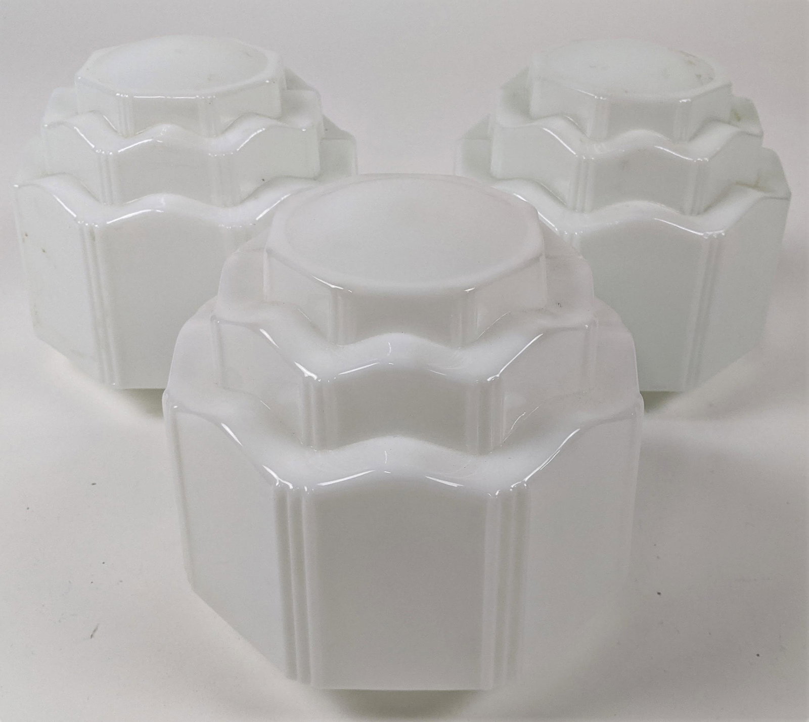 Three Art Deco Milk Glass Shades: Three Art Deco milk glass shades. [8" H x 3 3/4" Diam.]. In good condition.