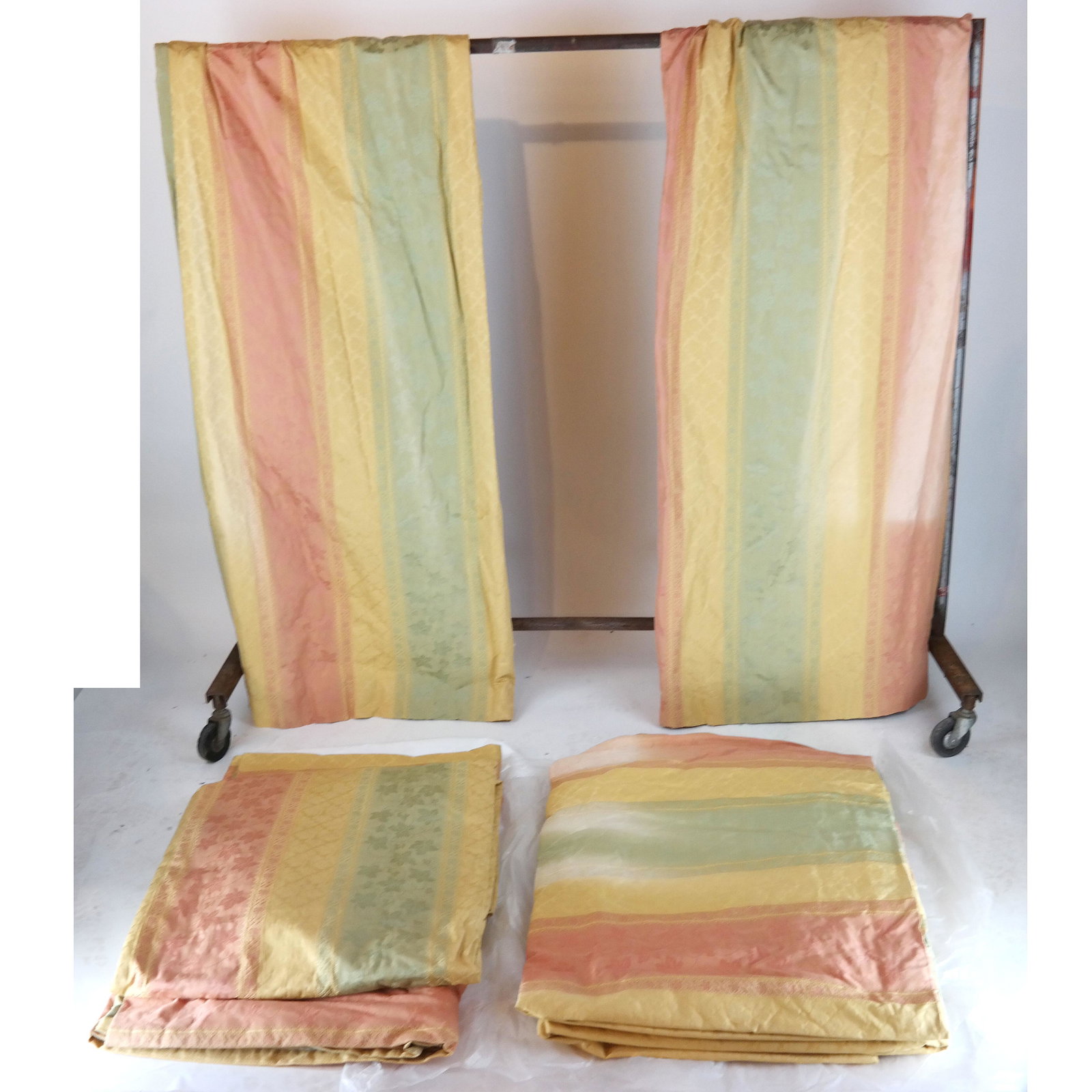 Italian 100% Cotton Drapery Fabric: 10 panels of Scalamandre retailed Colony of Rome 100% Italian cotton draperies, in colors rose, gold and jade. Lined and interlined. Rosettes probably placed on the outside. [Each panel: 105" L x 52" 