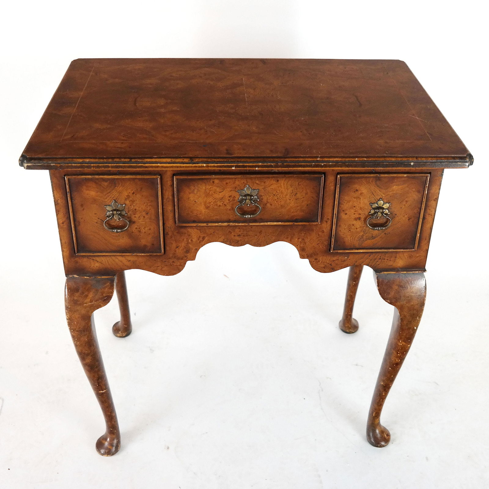 Queen Anne-Style Lowboy: Queen Anne-style lowboy, burled and line inlaid, with three drawers, on pad feet. [27" H x 27" W x 18" D]. In good condition.