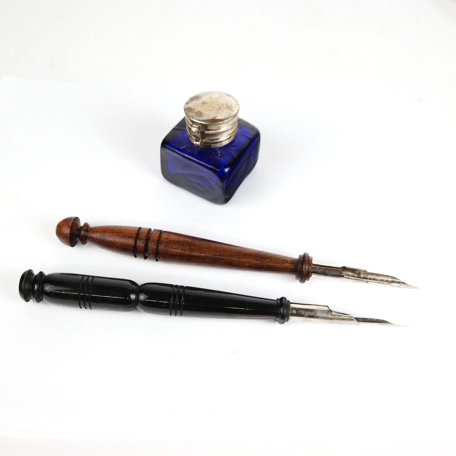 Tessellated Bone & Scrimshaw Box: Tessellated bone box with nautical scrimshaw cover, containing two pens and an inkwell. [2 1/4" H x 10 1/4" W x 2 3/8" D]. In good condition.