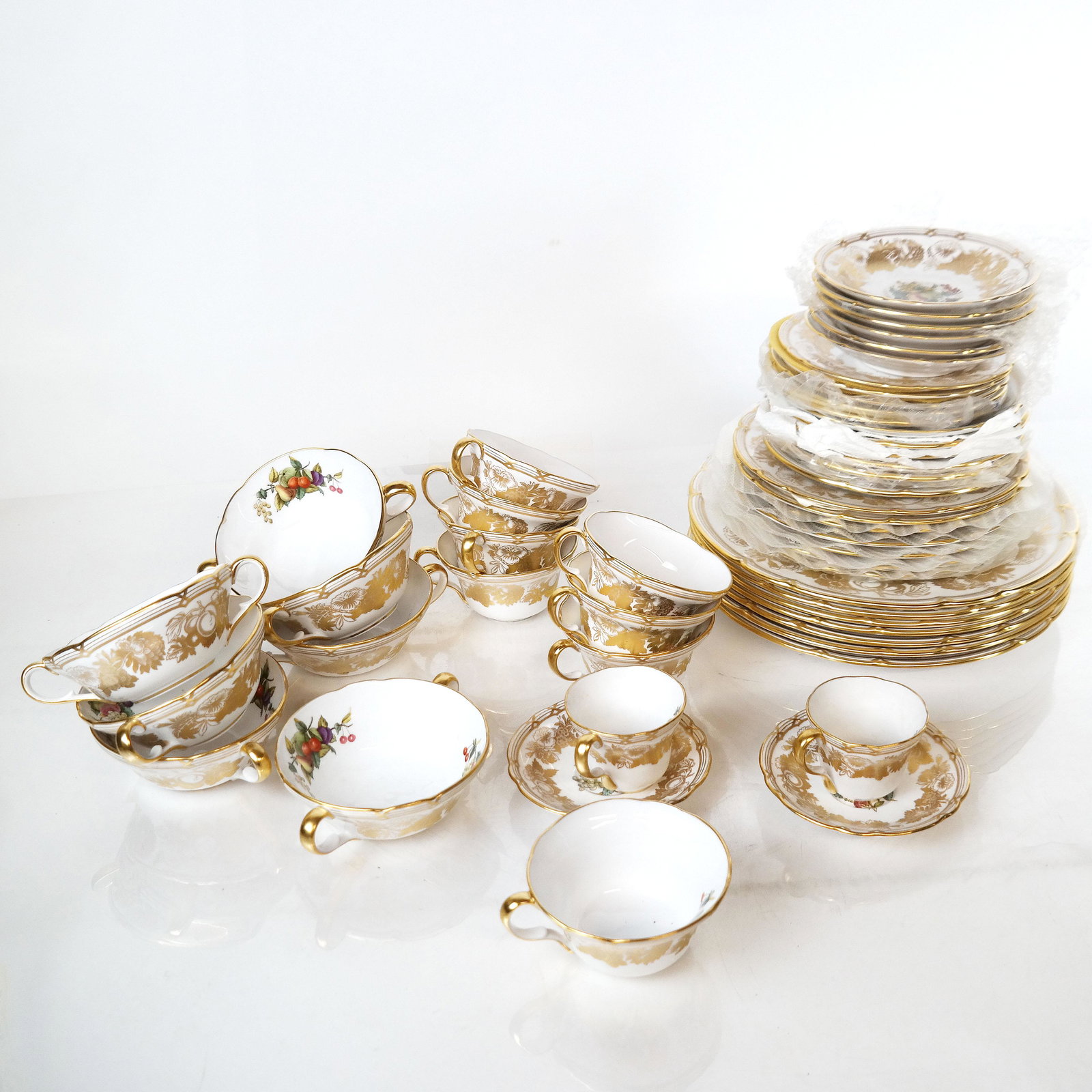 Spode Bone China Partial Dinner Service: Spode, England bone china dinner service for 6, in pattern V7049, comprising 36+ pieces. One demitasse cup broken (pieces present); otherwise no chips, cracks or repairs.