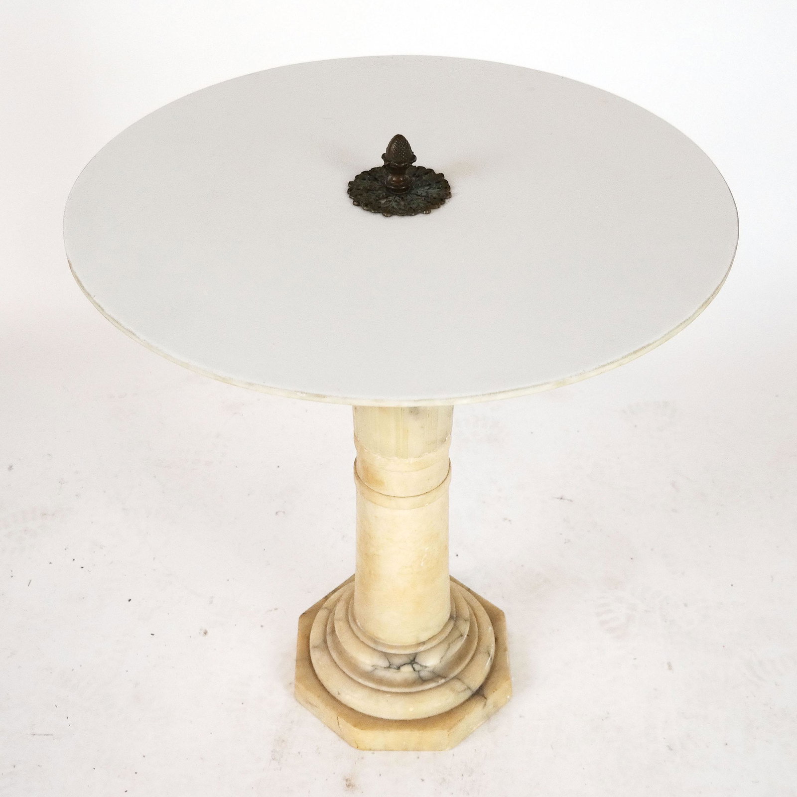 Alabaster & Slate Circular Table: Table having a cream alabaster column base with a drilled circular white slate top, with an acorn finial. [24" H x 22" Diam. (not including finial). Finial: 2 1/2" H].