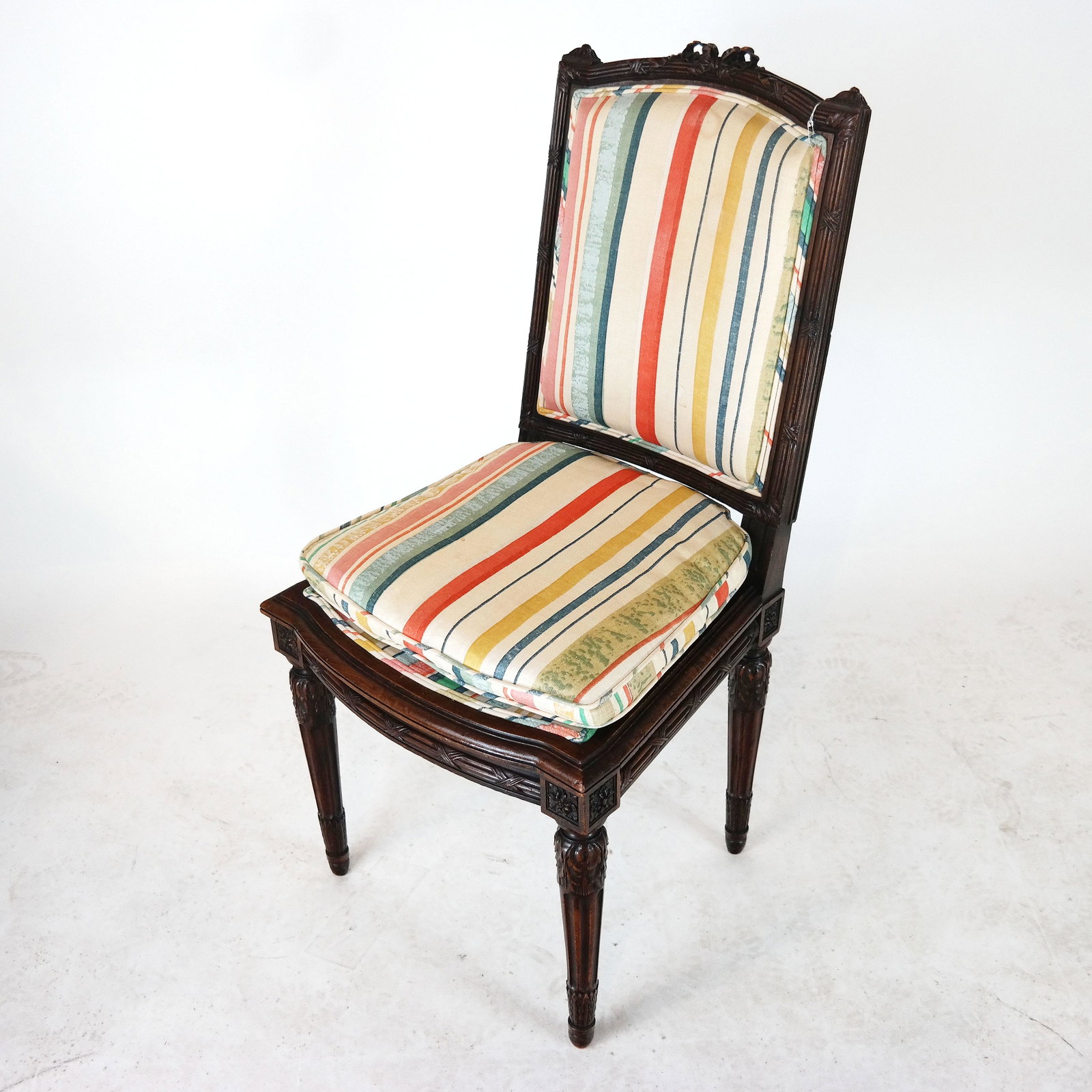 Antique Louis XVI-Style Side Chair: Side chair of carved walnut with fluted sides and legs, pad seat, upholstered back. [39" H x 19" W x 22" D].