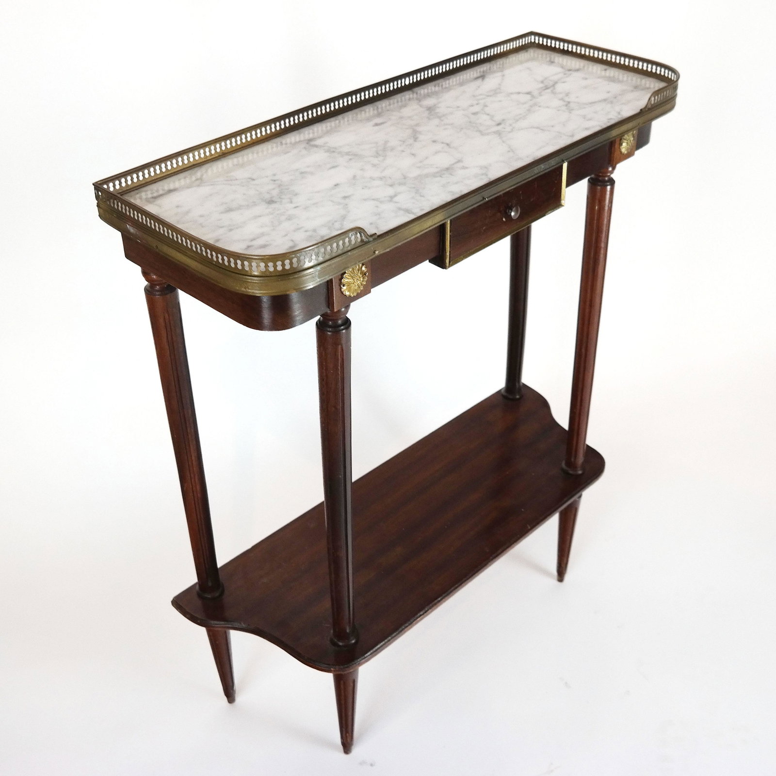 Louis XVI-Style D-Shaped Console: Mid-20th century console with 3/4 galleried inset marble top, having a lower tier and one drawer. [31 1/2" H x 27" W x 10" D]. In good condition.