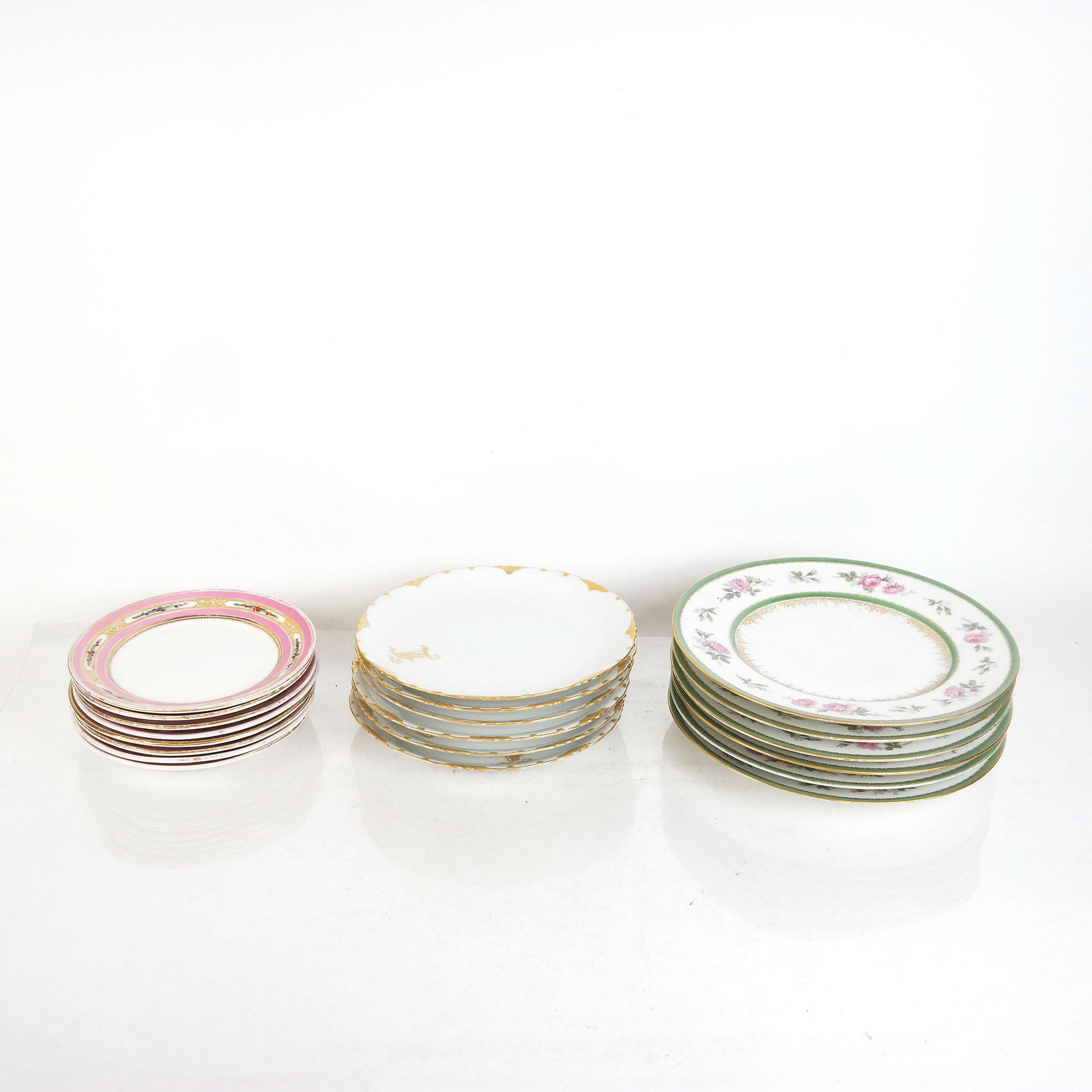 Three Sets of Porcelain Plates: Lot includes: Six (6) Bernardaud, Limoges plates [9 5/8" Diam.], eight (8) pink and gilt plates with gold number marks on bottom [7" Diam.], and six (6) Rosenthal Bavaria white and gilt plates, with "