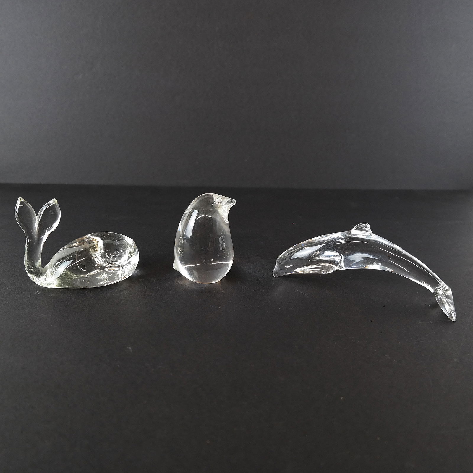 Baccarat, Steuben, Other Three Animals: Three crystal sculptures of a dolphin, whale, and penguin. [Penguin with chip.