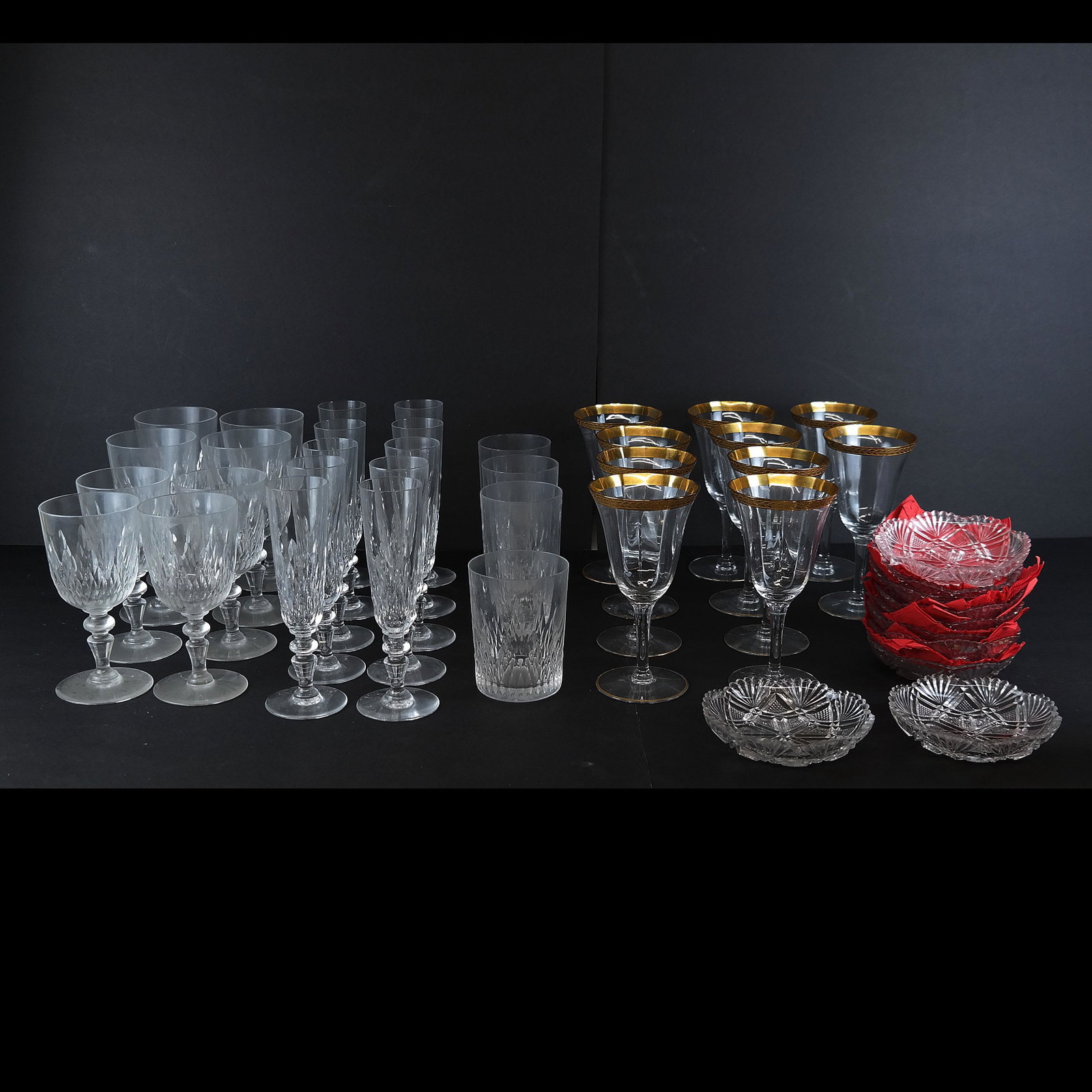 Lot of Cut Crystal & Crystal Glasses (42 Pcs.): Lot includes cut crystal stemware and rock glasses [Flutes: 7 1/4" H], together with 10 matching cut glass nut or trinket dishes [5" Diam.] and 10 gilt crystal wine glasses [6 1/2" H]. In good conditi