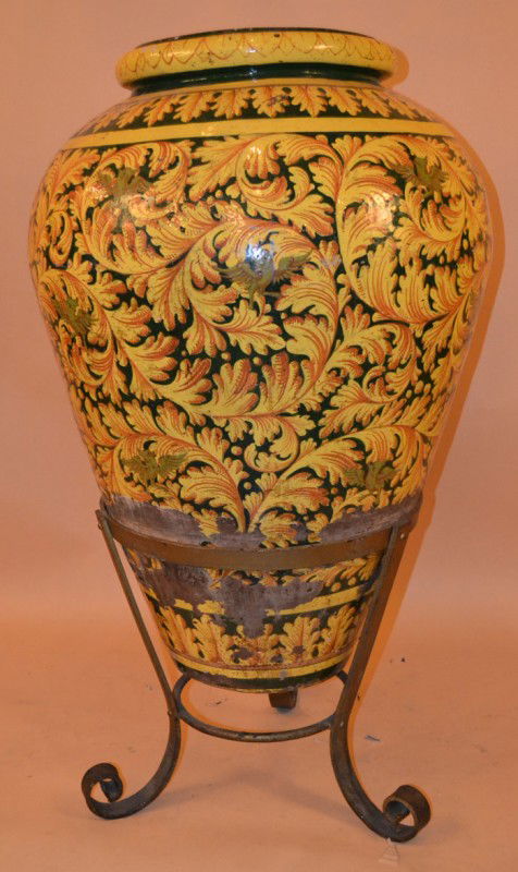 Faience Palace Urn on Stand: Having leaves and birds in yellow and black glaze set into a frame, having three scrolling legs 37" x 46"