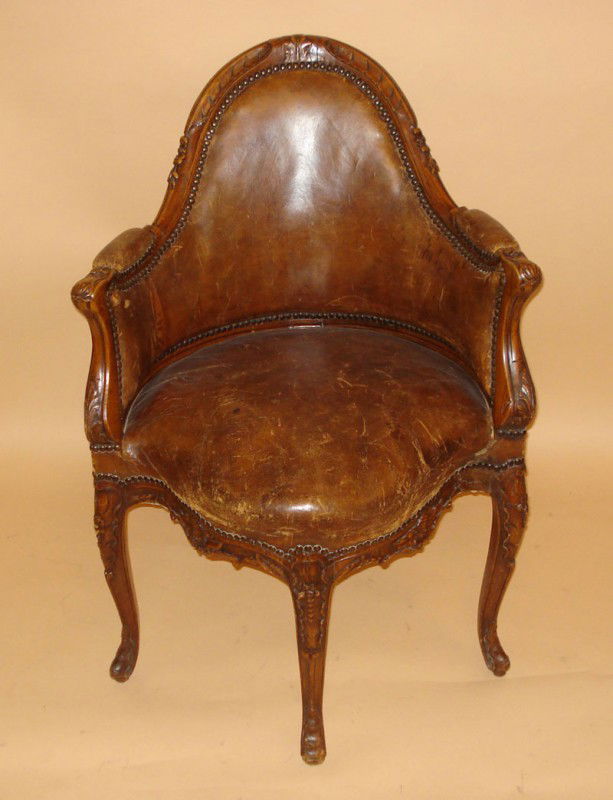 Corner Chair, Antique Continental: An antique leather upholstered chair. Shell, floral & leaf carving, having rivet trim. 36 1/2"H (Back)