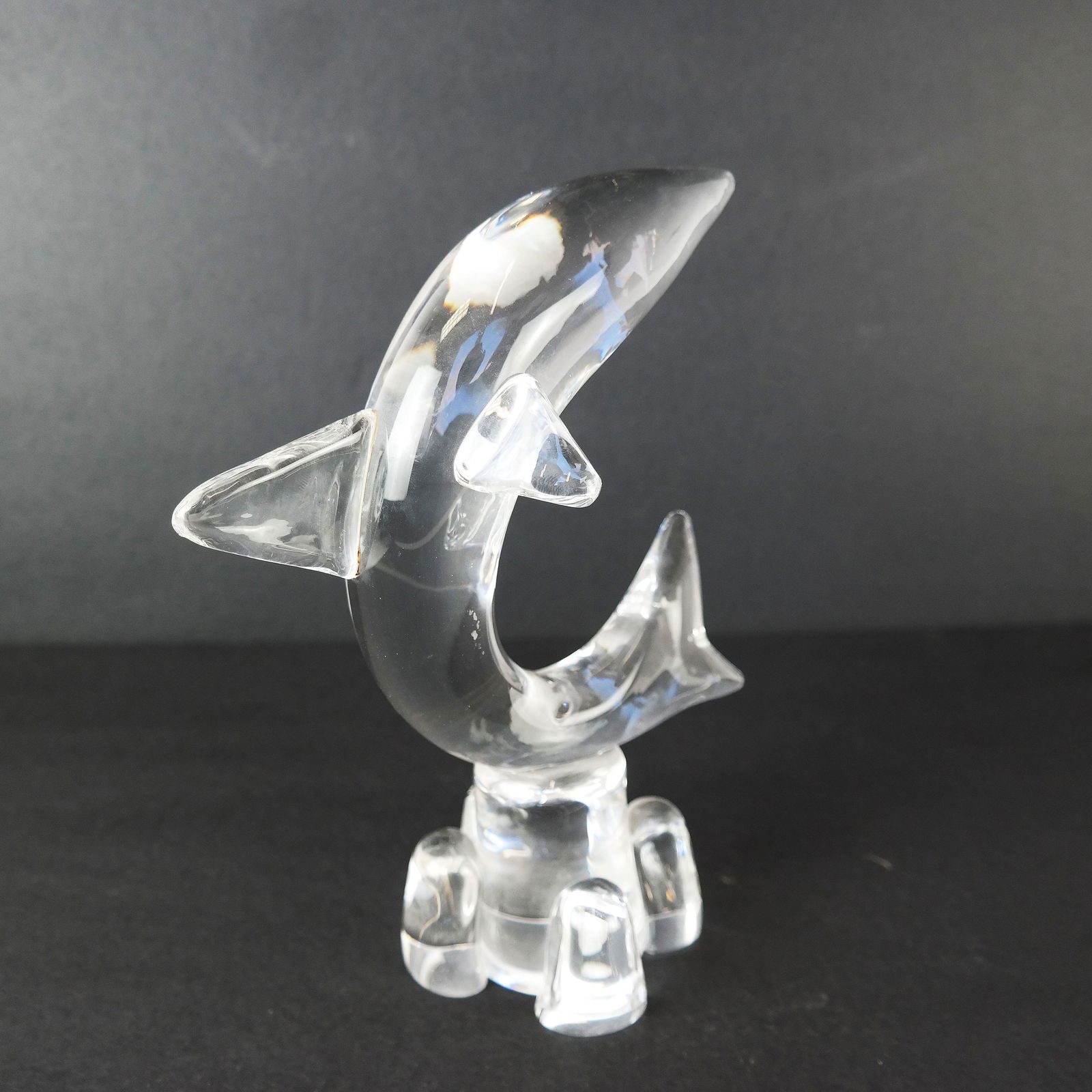 Steuben Dolphin Sculpture/Paper Weight: Sculpture of jumping dolphin on self base. [9" H x 6" W x 4" D]. In good condition.