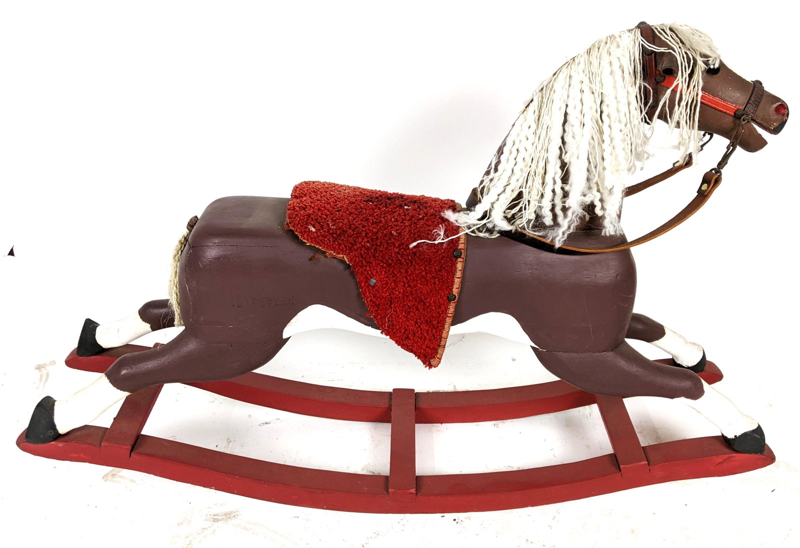 Vintage Carved Wood Rocking Horse: Vintage carved, red and brown painted rocking horse. [28" H x 41" W x 9 1/2" D]. In good condition.