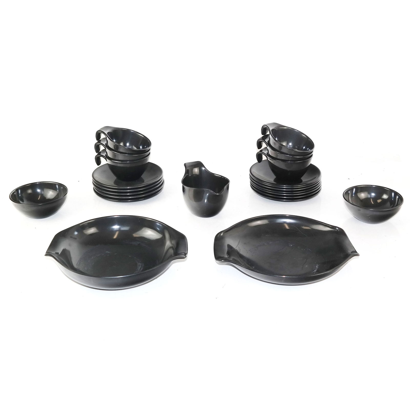 Russell Wright Dessert Ware: 20 pieces of Russel Wright black plastic dessert ware. [Largest bowl: 9" Diam.]. In good condition.