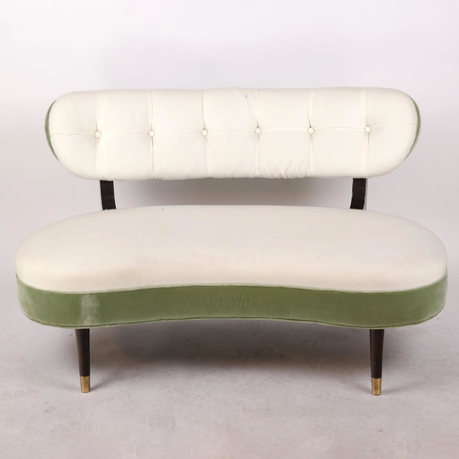 Modern Green & White Settee: Modern contemporary shaped settee, having a black gloss frame and green upholstery. [31" H x 50" W x 26" D; 15" to seat]. White stained back left.