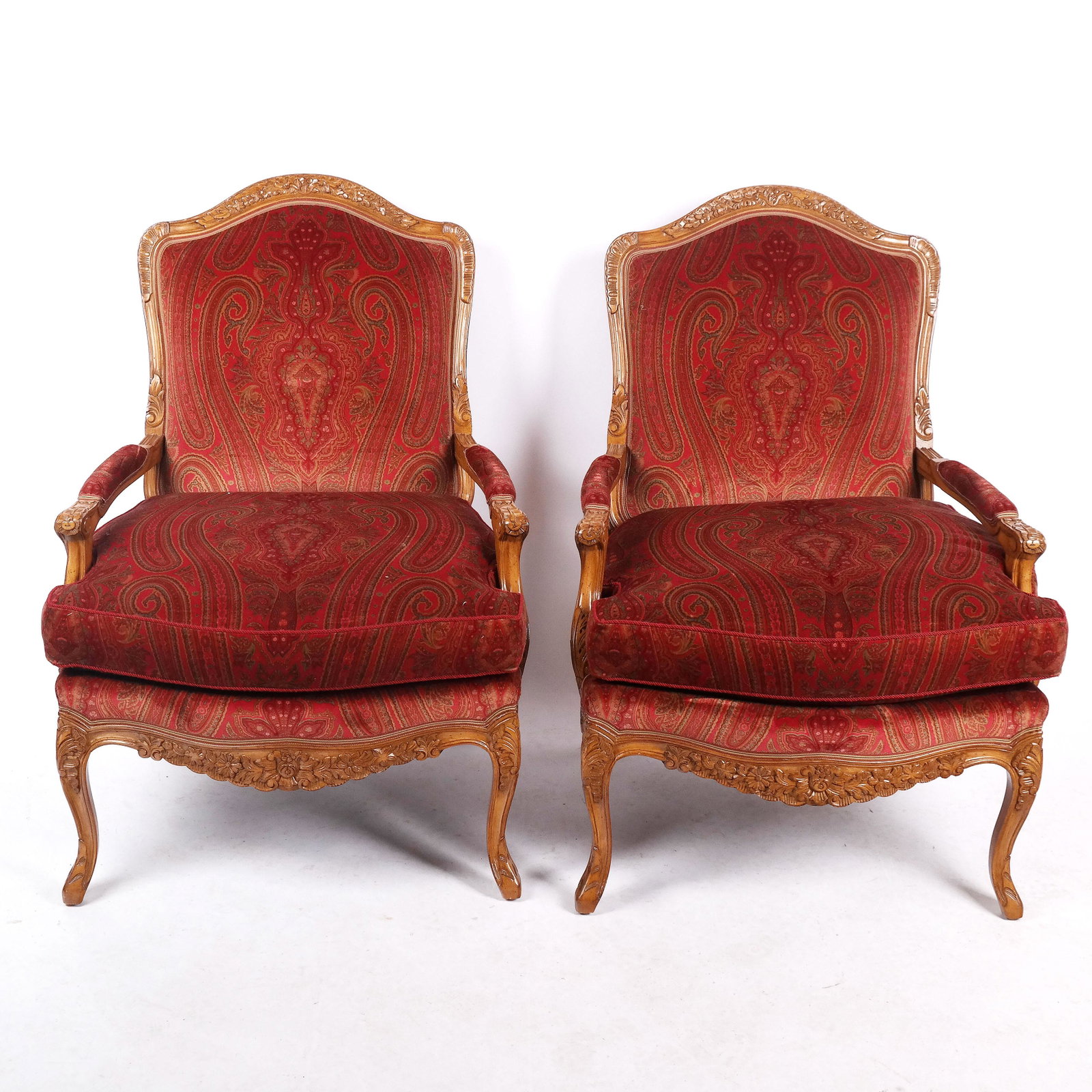 Pair of French Carved Walnut Marquise Armchairs: Pair of antique French carved walnut marquise armchairs with red floral velveteen upholstery. [43" H x 30" W x 25 1/2" D]. In good condition; upholstery with fading.