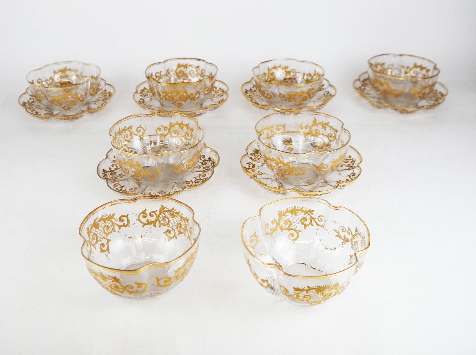 Baccarat-Style Bowls & Underplates: Porcelain lot, decorated with finely gilt encrusted scrolls and gilt trim. [8 bowls: 3" H x 5 1/4" Diam.; 6 underplates: 7" Diam.]. In good condition.