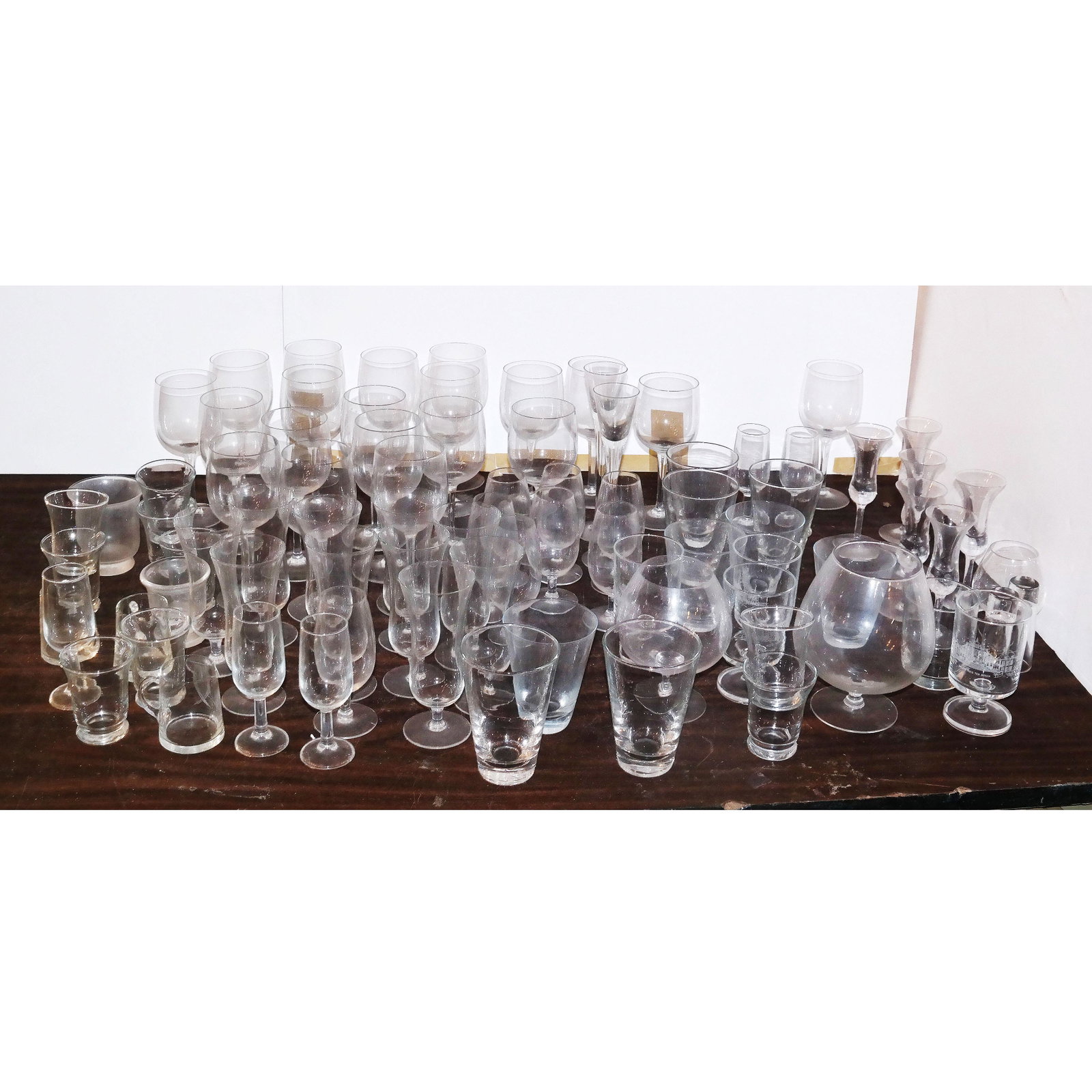 Large Lot of Glassware: Wine stems, glasses, cups, Brandy's, etc. In good condition.