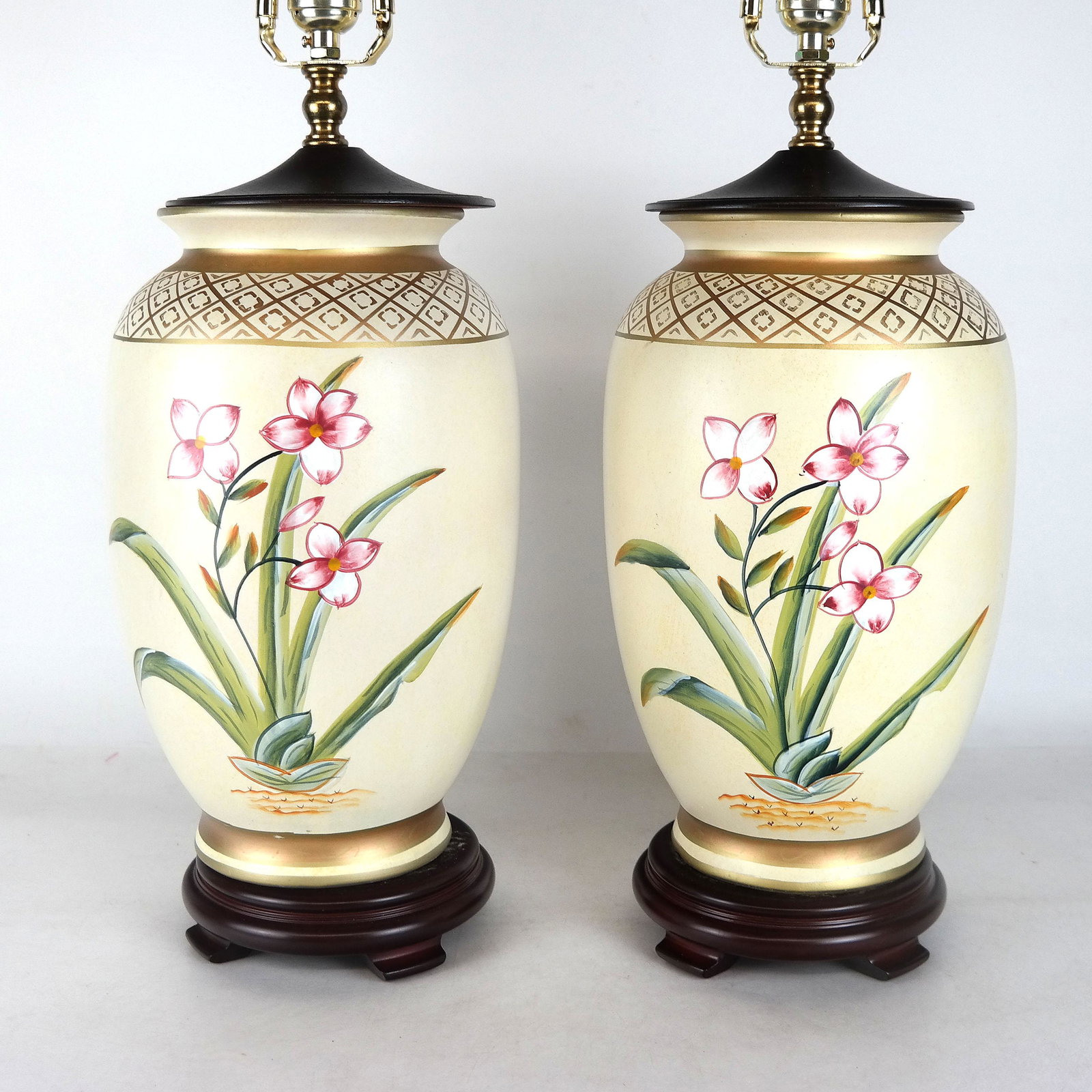 Pair of Floral Decorated Porcelain Vase Lamps: Pair of porcelain vase lamps in floral and gilt with wooden tops and bases. [30" H x 8" Diam.].