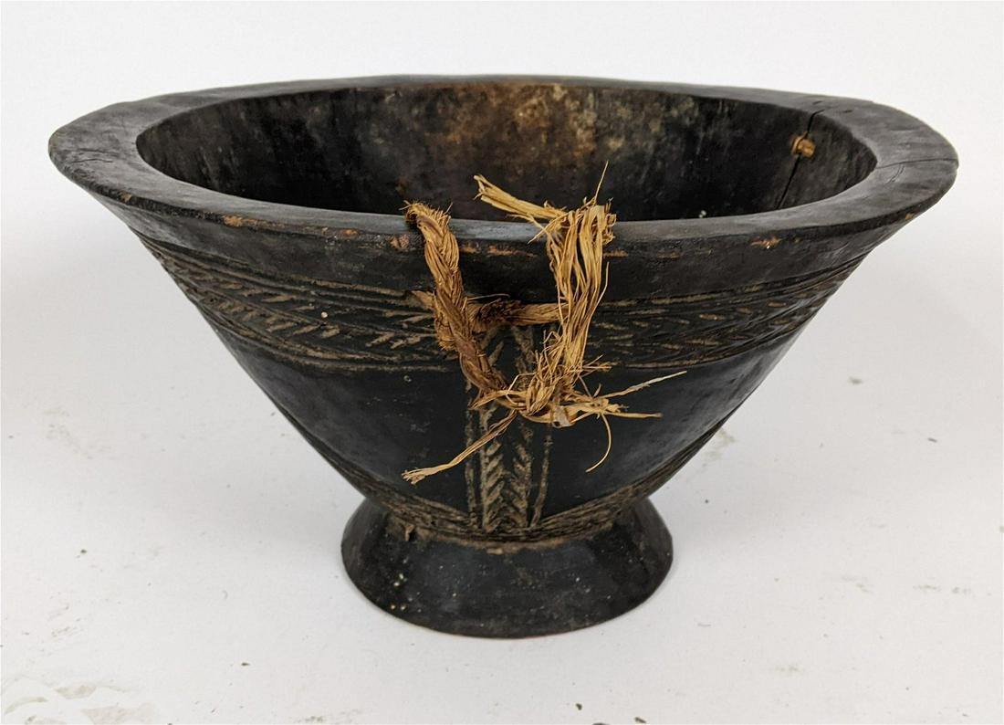 African Carved Wood Bowl: Antique African large carved wood bowl. [9 1/2" H x 17" Diam.]. In good condition. LOCATED AT 100 CARNEY ST